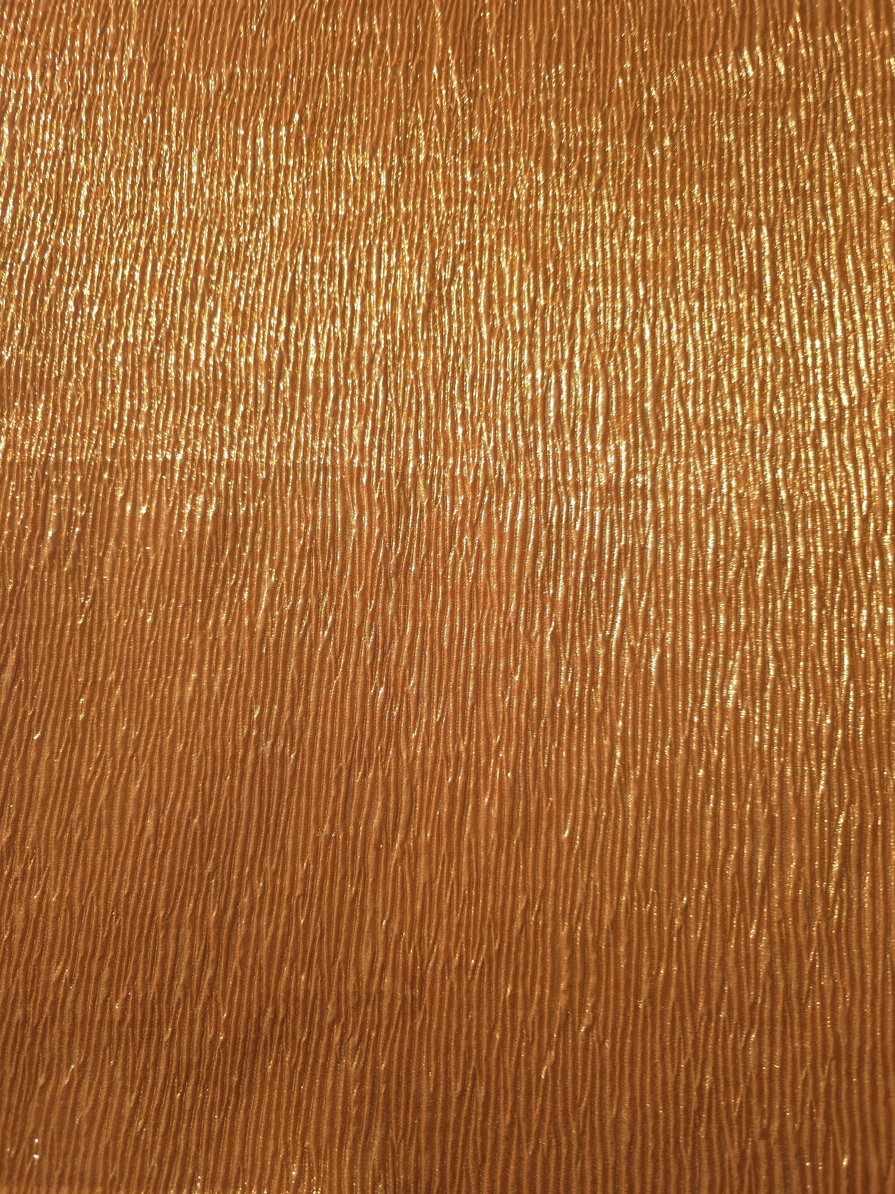 Surface detail of Burnished Copper fine mini-plissé shimmer fabric showcases narrow micro-pleated texture for evening clutches, garment accents and special-occasion pieces.