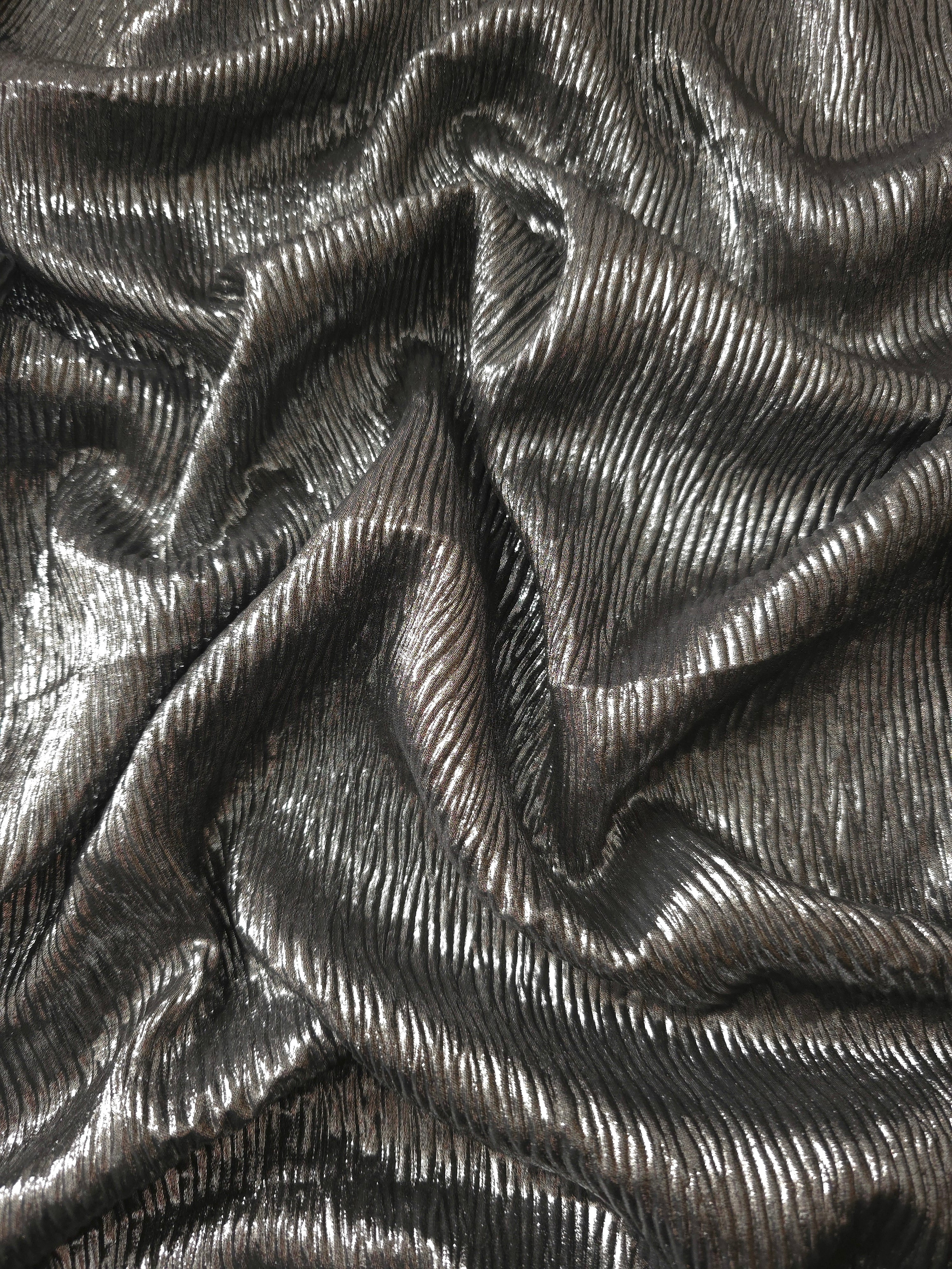 Flowing drape of Graphite Gray fine mini-plissé shimmer fabric, showing narrow micro-pleated texture and light-catching movement for evening gowns and flowing maxi skirts.