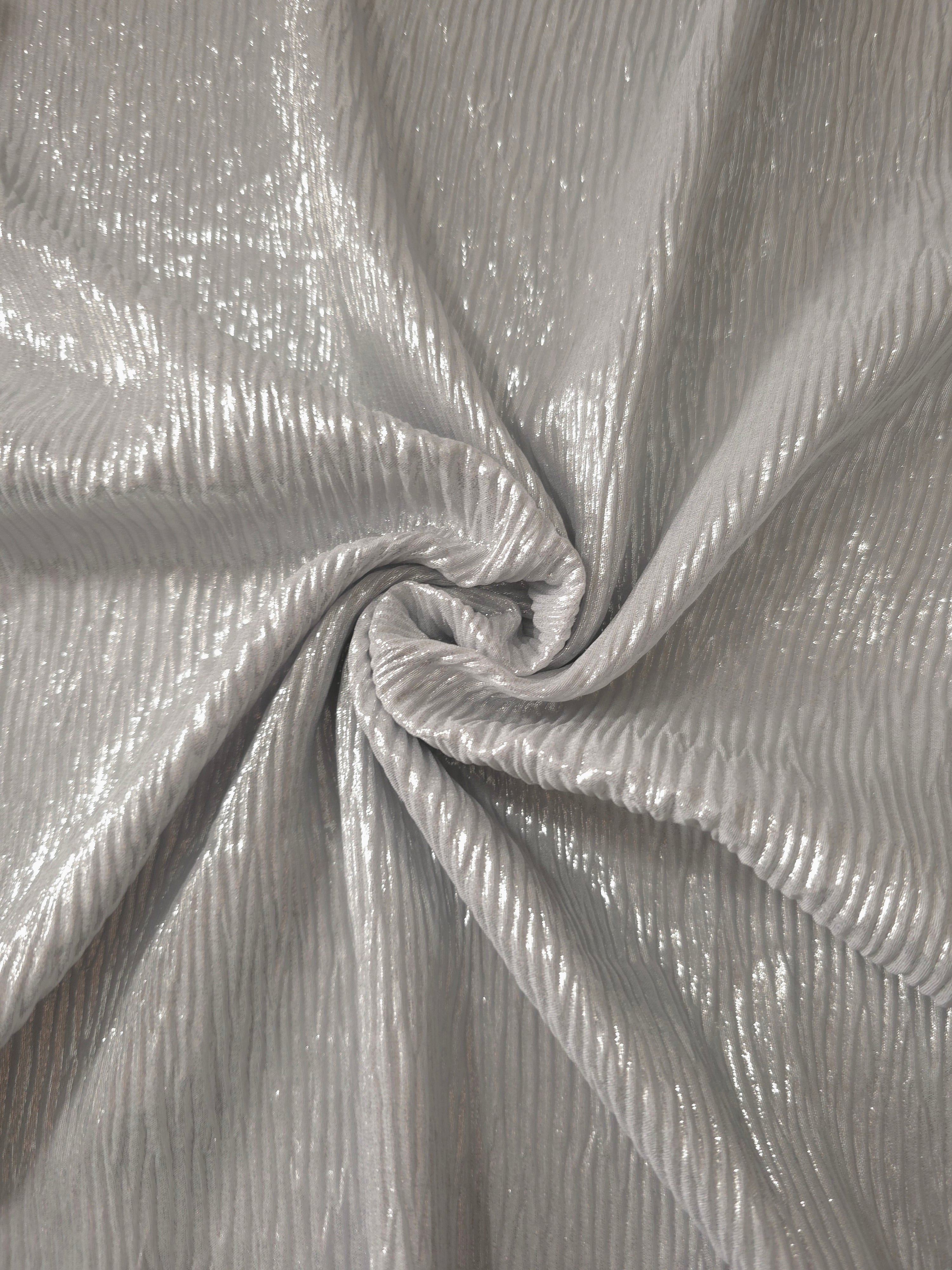 Fold detail of Pearl Silver fine mini-plissé fabric demonstrates how the textured surface builds depth for stagewear and layered fashion details.