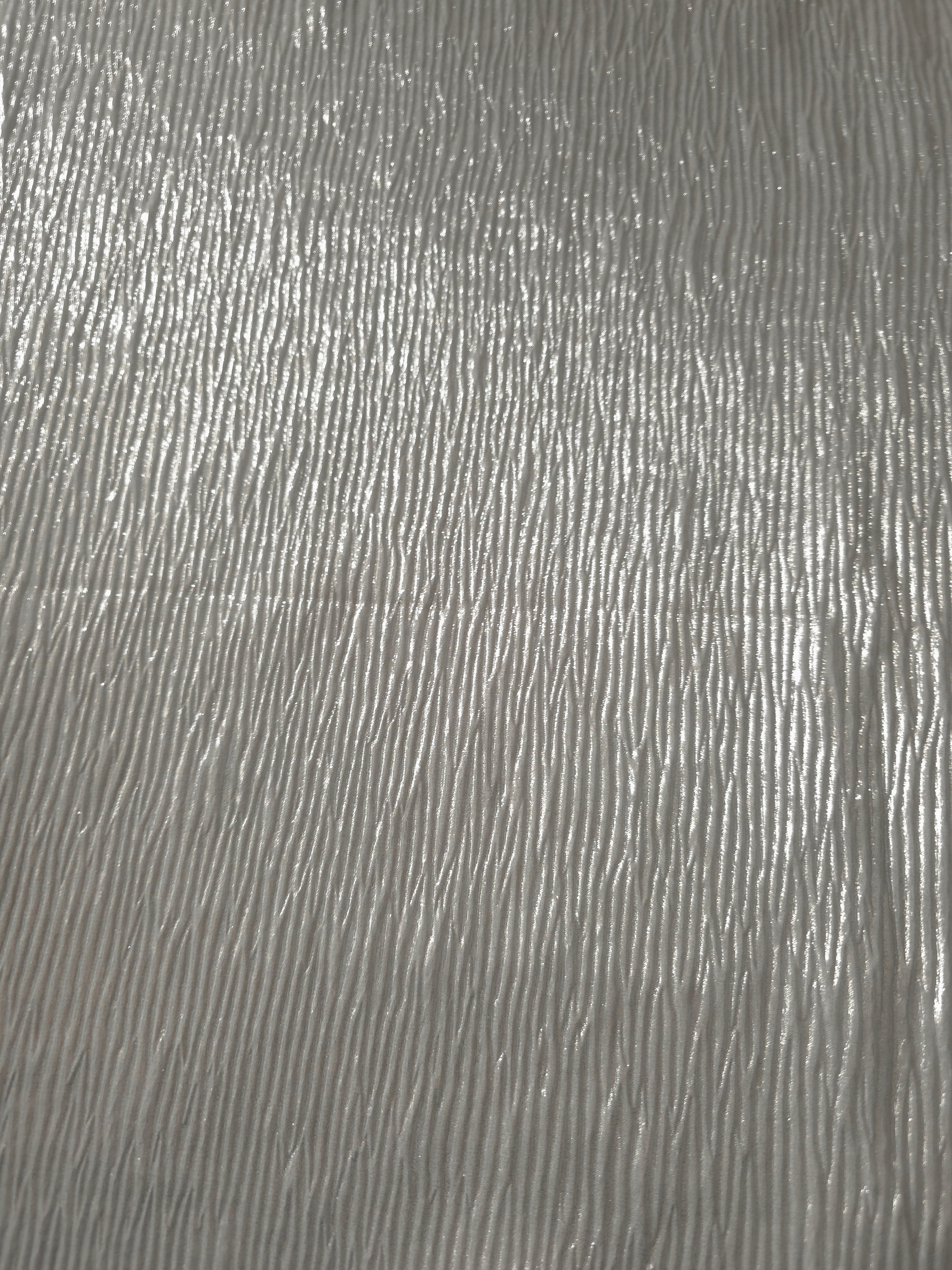 Surface detail of Pearl Silver fine mini-plissé shimmer fabric showcases narrow micro-pleated texture for evening clutches, garment accents and special-occasion pieces.