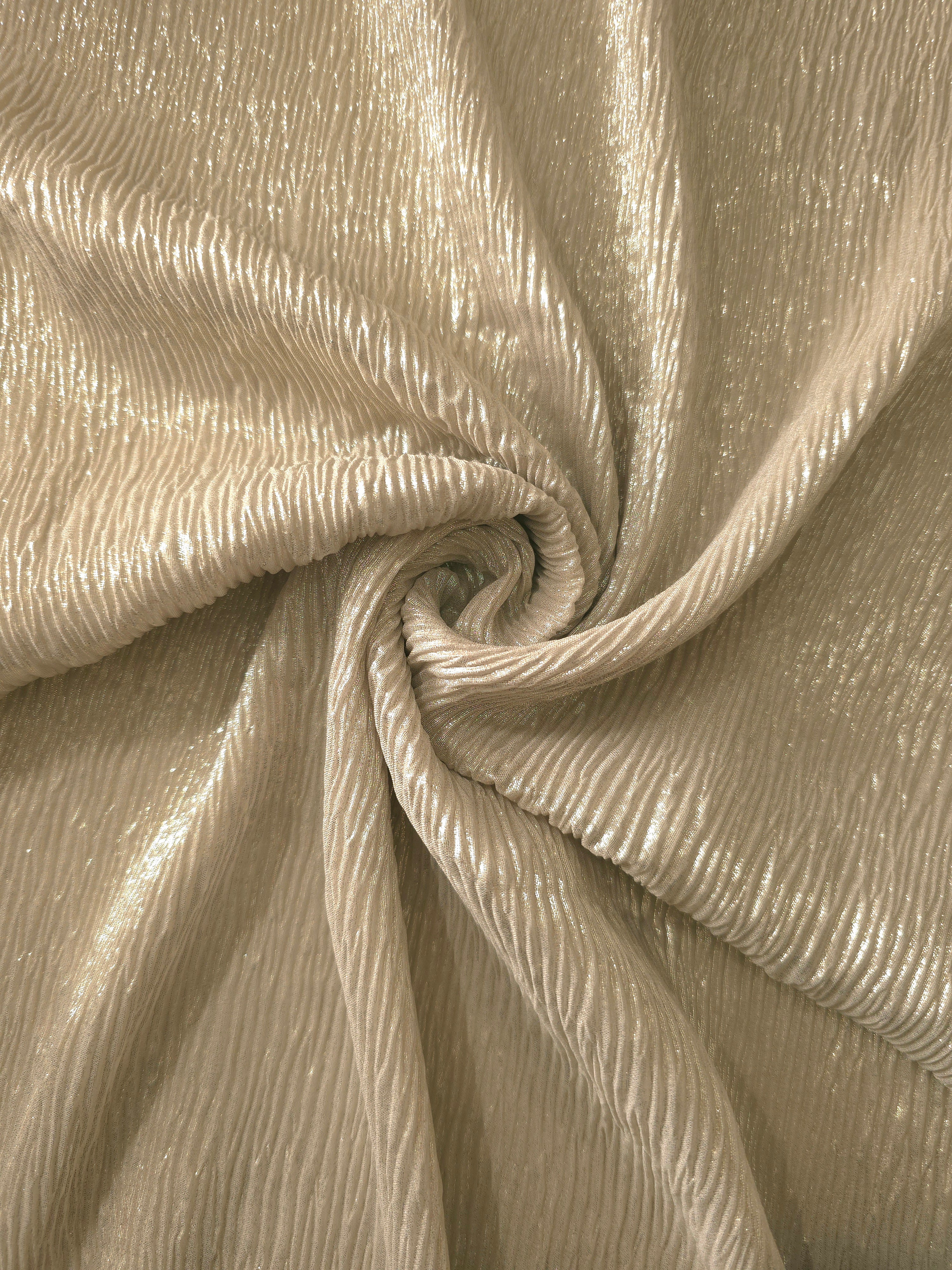 Fold detail of Soft Champagne fine mini-plissé fabric demonstrates how the textured surface builds depth for stagewear and layered fashion details.