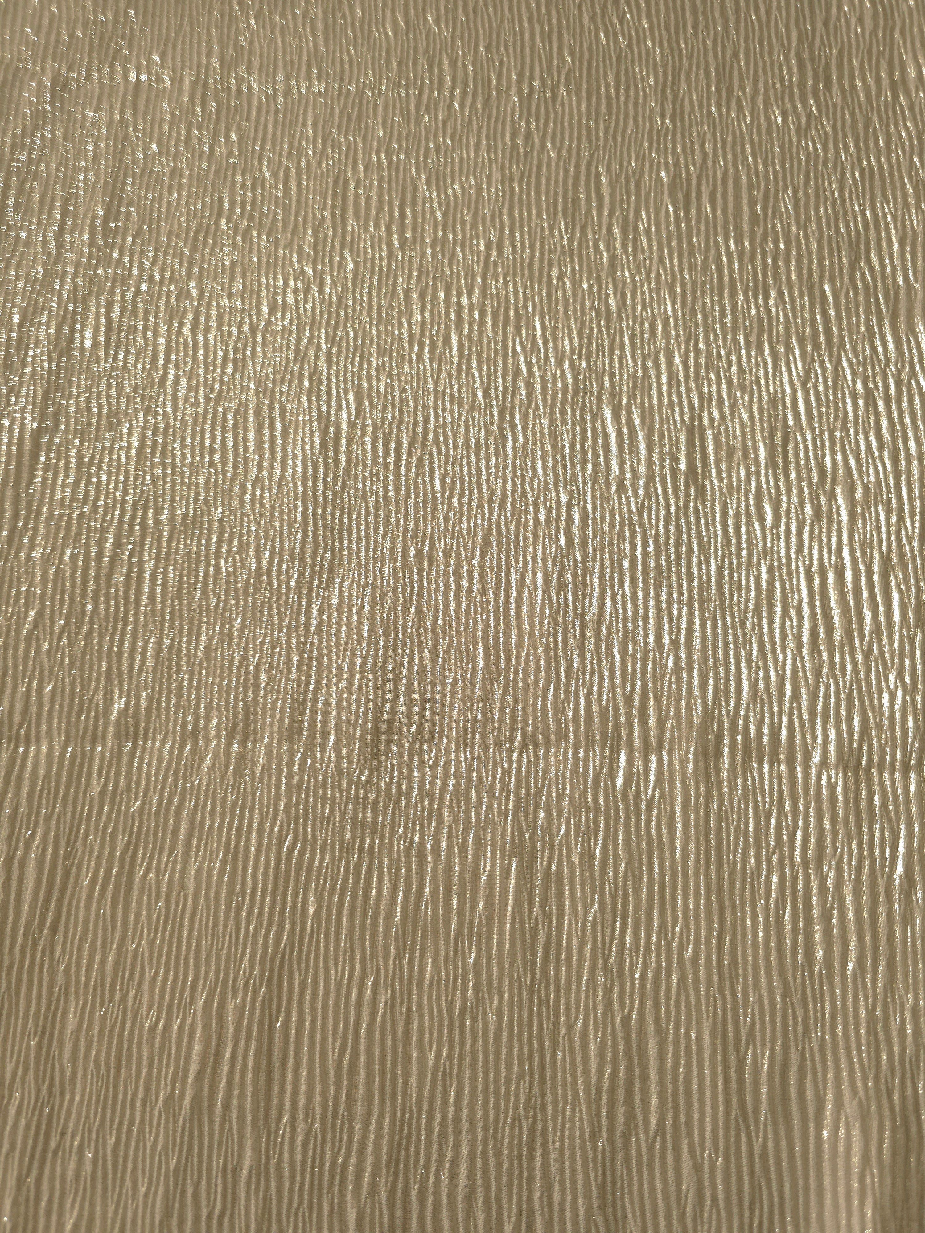 Surface detail of Soft Champagne fine mini-plissé shimmer fabric showcases narrow micro-pleated texture for evening clutches, garment accents and special-occasion pieces.