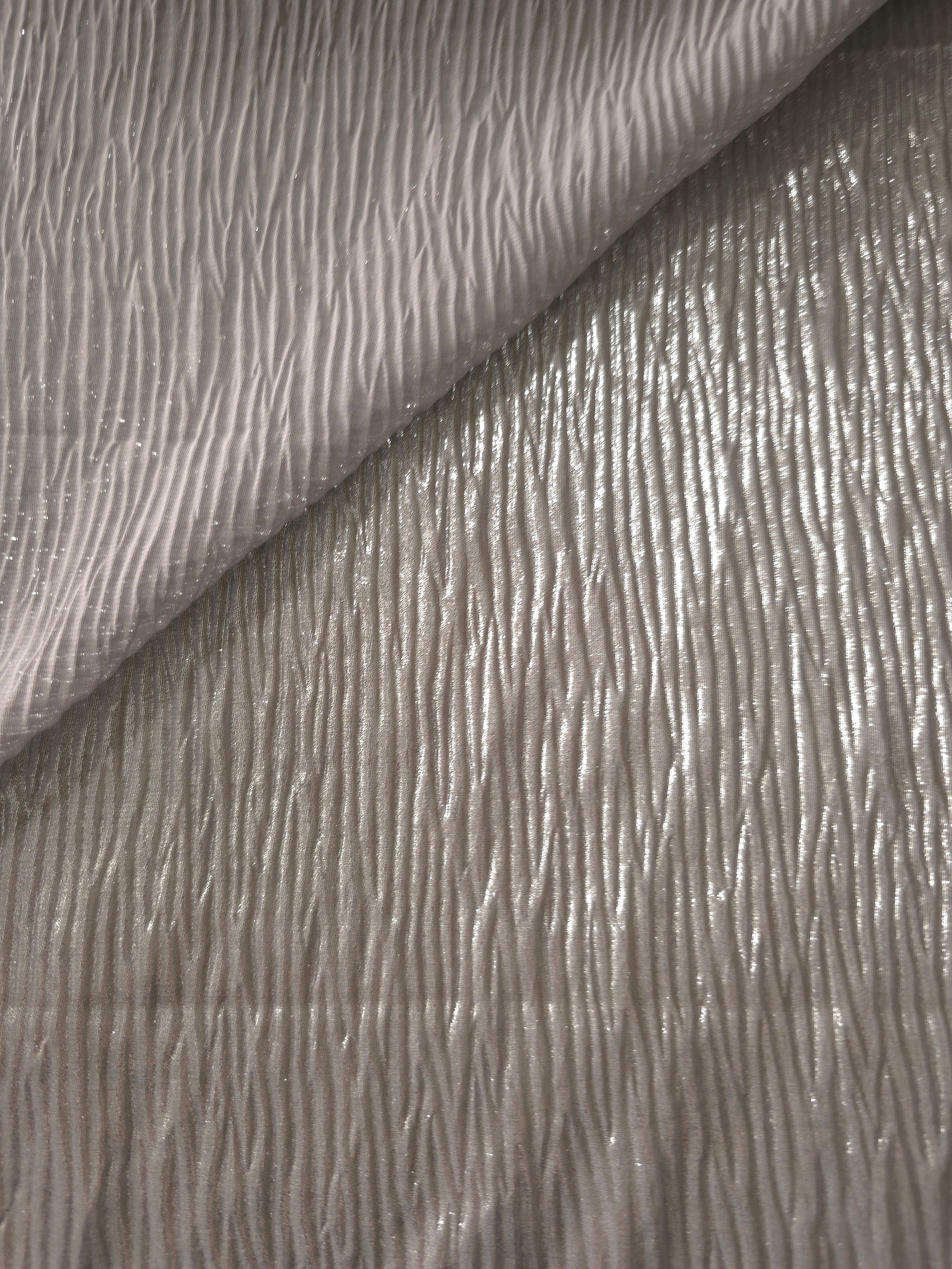 Fold detail of Steel Silver fine mini-plissé fabric demonstrates how the textured surface builds depth for stagewear and layered fashion details.