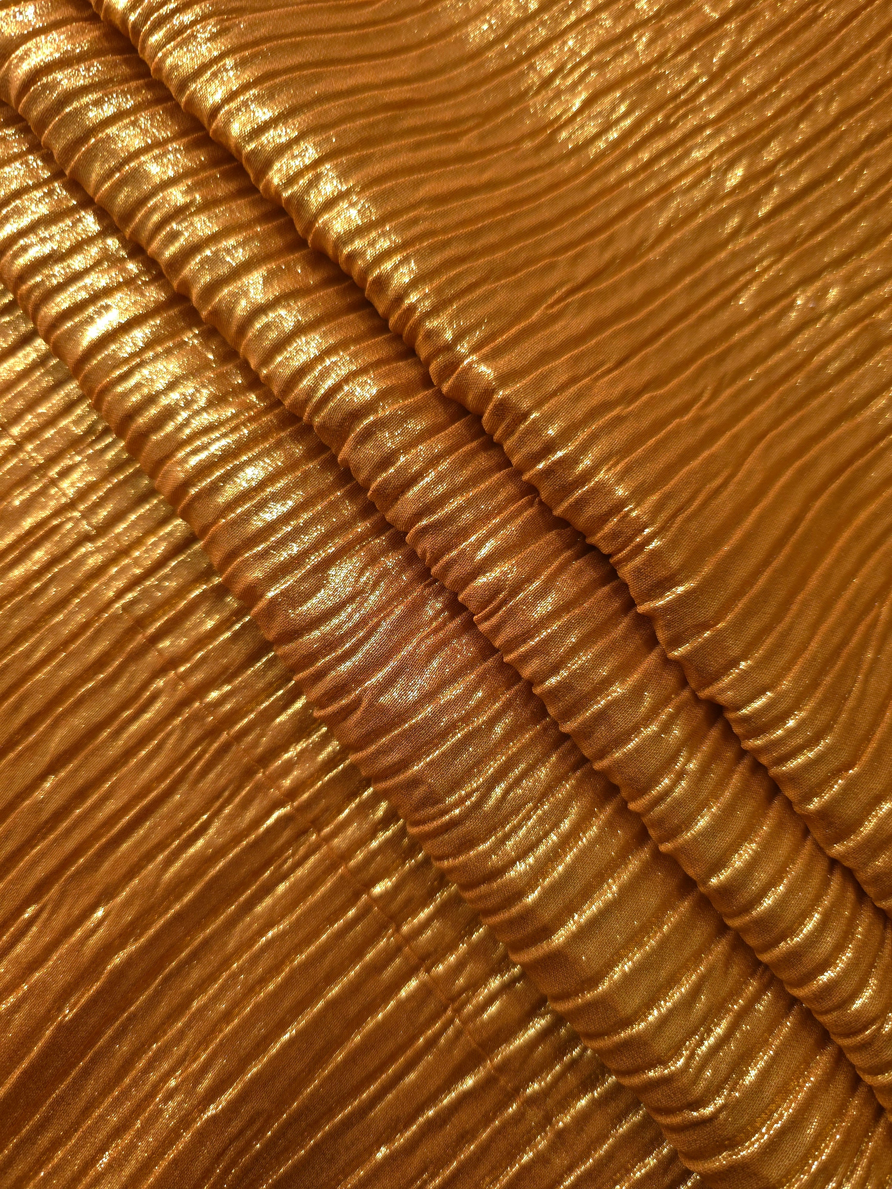 Amber Gold classic plissé fabric in close detail, revealing the fine shimmer and dimensional pleat structure suited to bodice accents and fashion-forward blouses.
