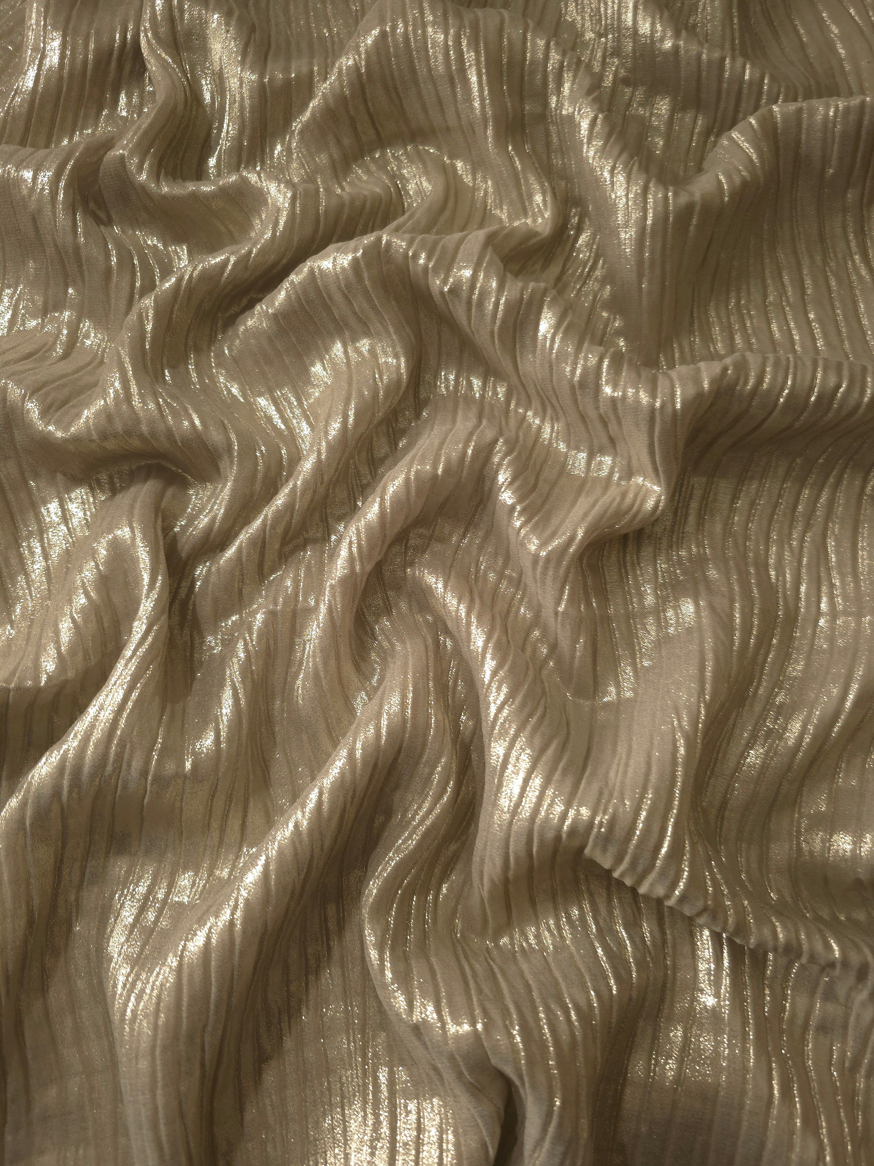 Flowing drape of Champagne Taupe classic plissé shimmer fabric, showing regular pleated texture and light-catching movement for evening gowns and flowing maxi skirts.