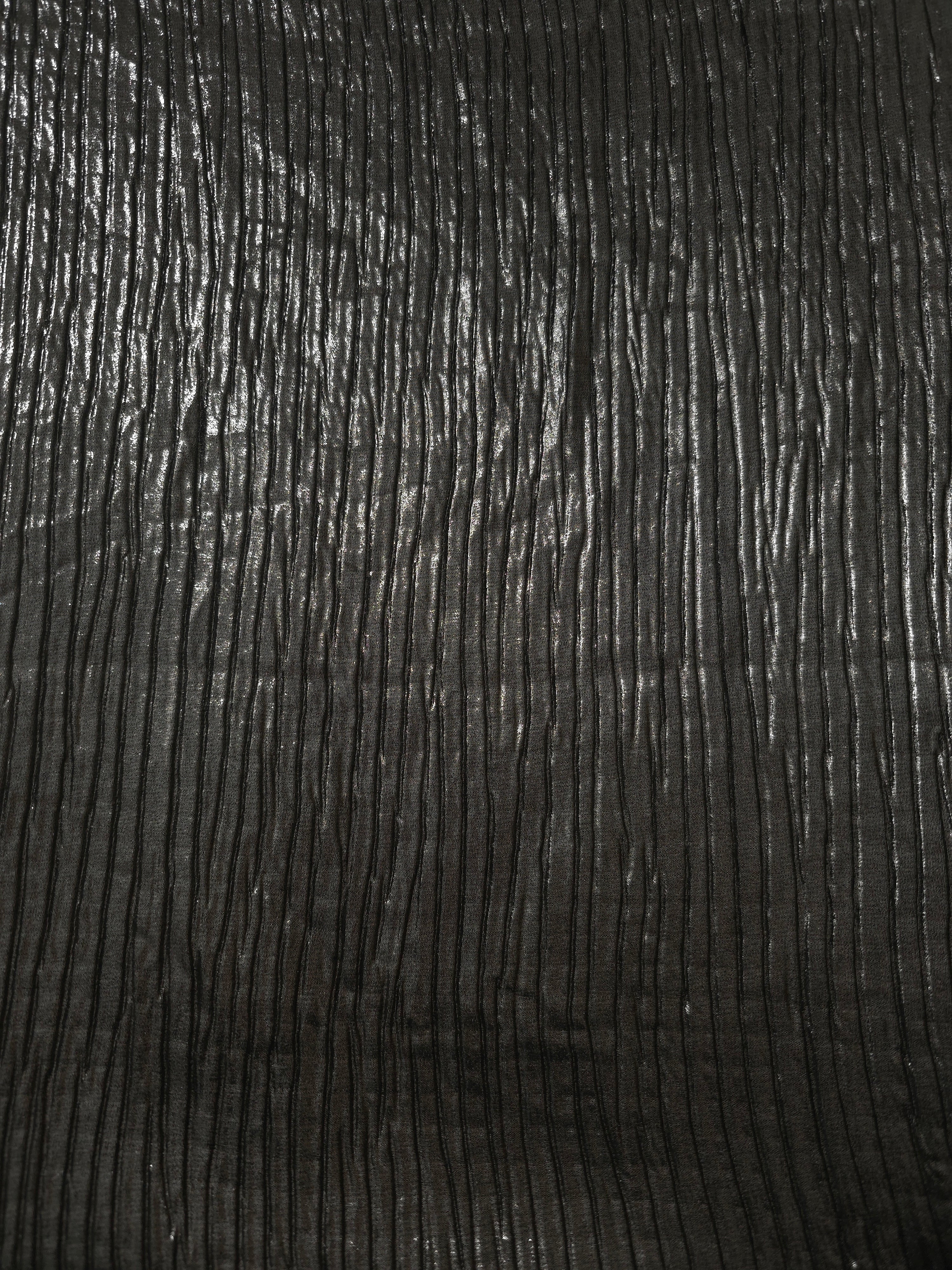 Surface detail of Charcoal Black classic plissé shimmer fabric showcases regular pleated texture for evening clutches, garment accents and special-occasion pieces.