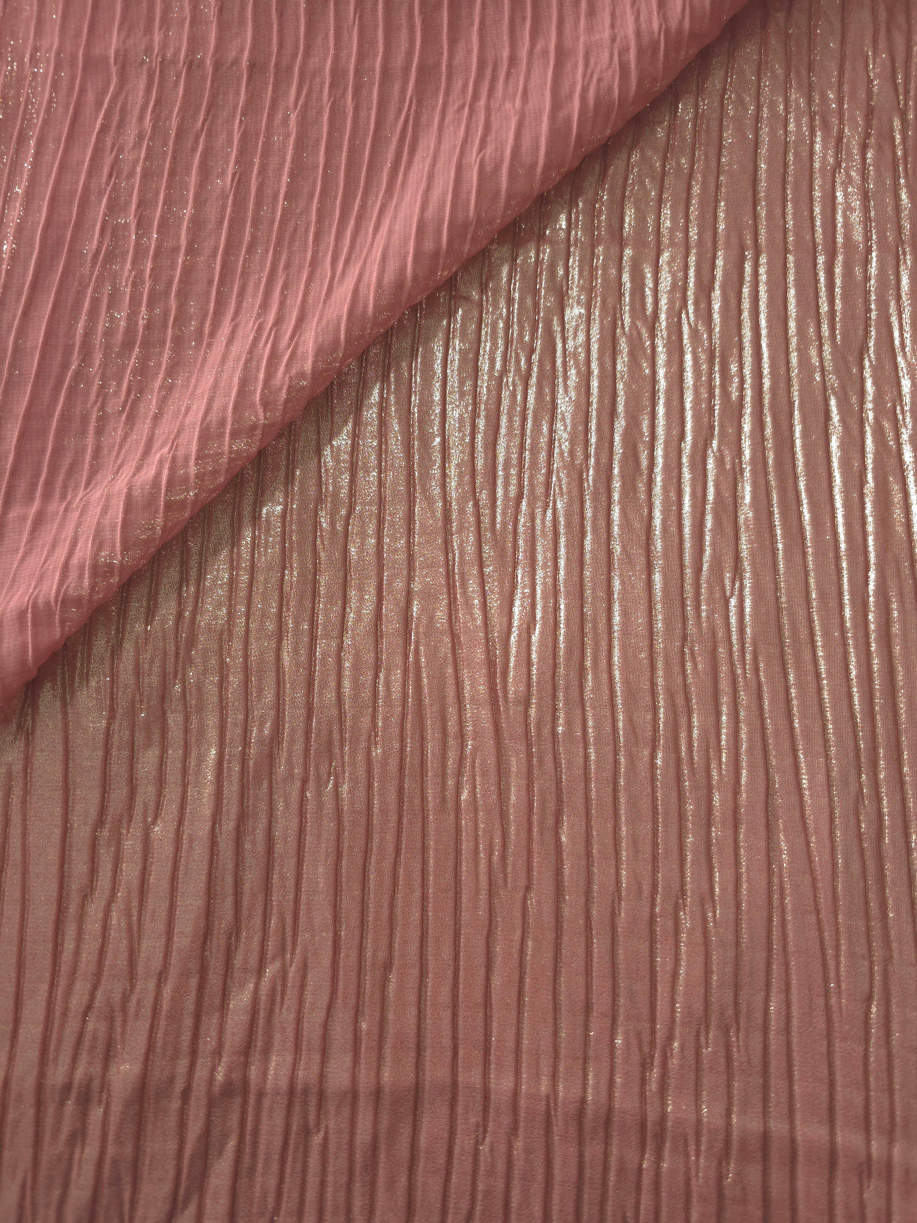 Fold detail of Dusty Rose classic plissé fabric demonstrates how the textured surface builds depth for stagewear and layered fashion details.