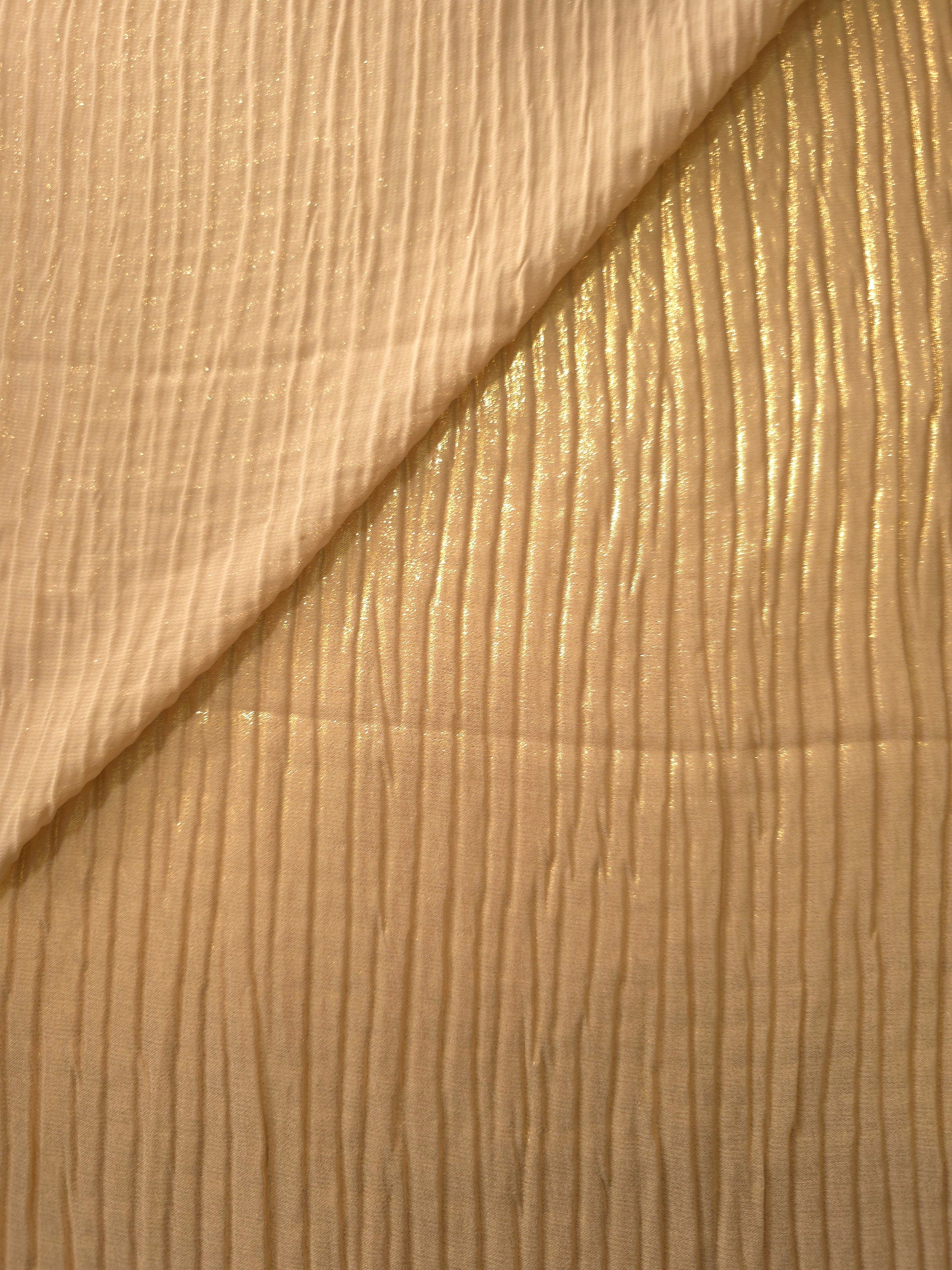 Fold detail of Golden Beige classic plissé fabric demonstrates how the textured surface builds depth for stagewear and layered fashion details.