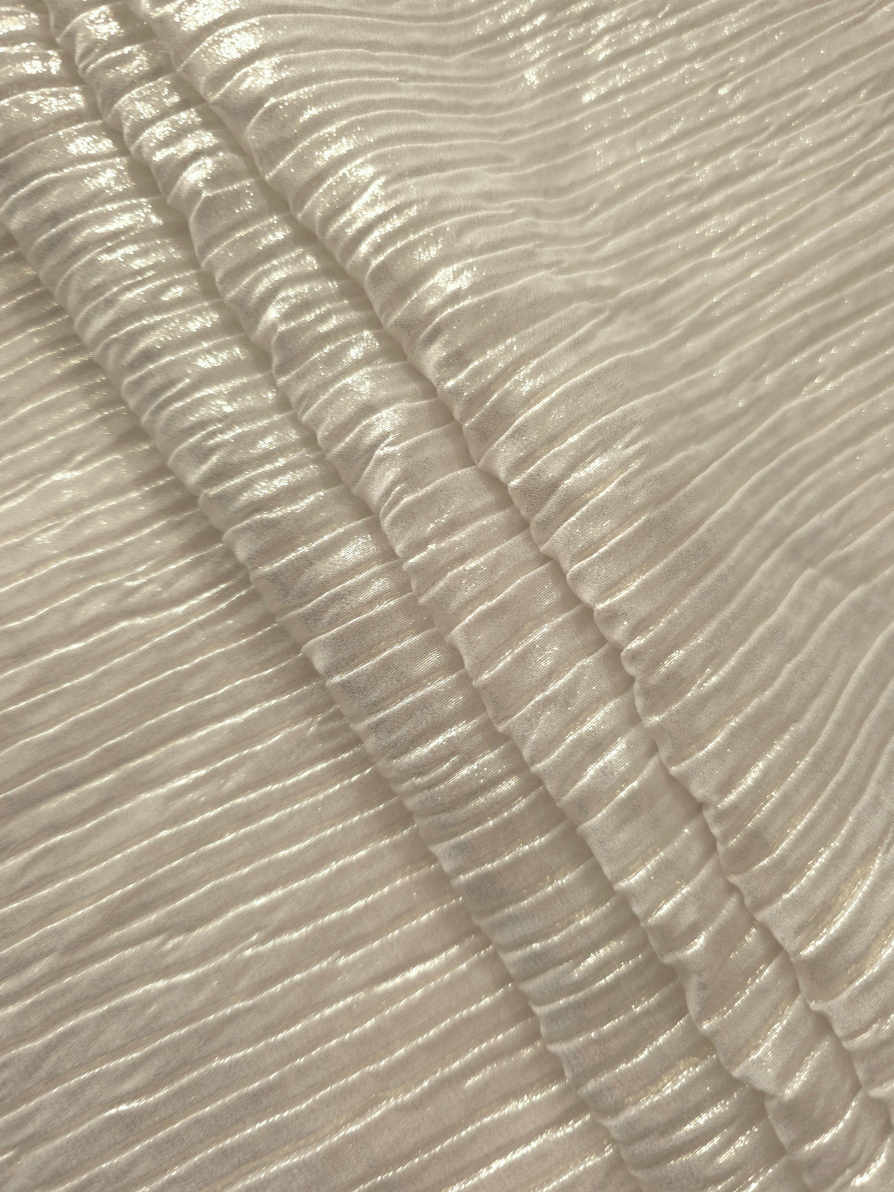 Ivory Cream classic plissé fabric in close detail, revealing the fine shimmer and dimensional pleat structure suited to bodice accents and fashion-forward blouses.