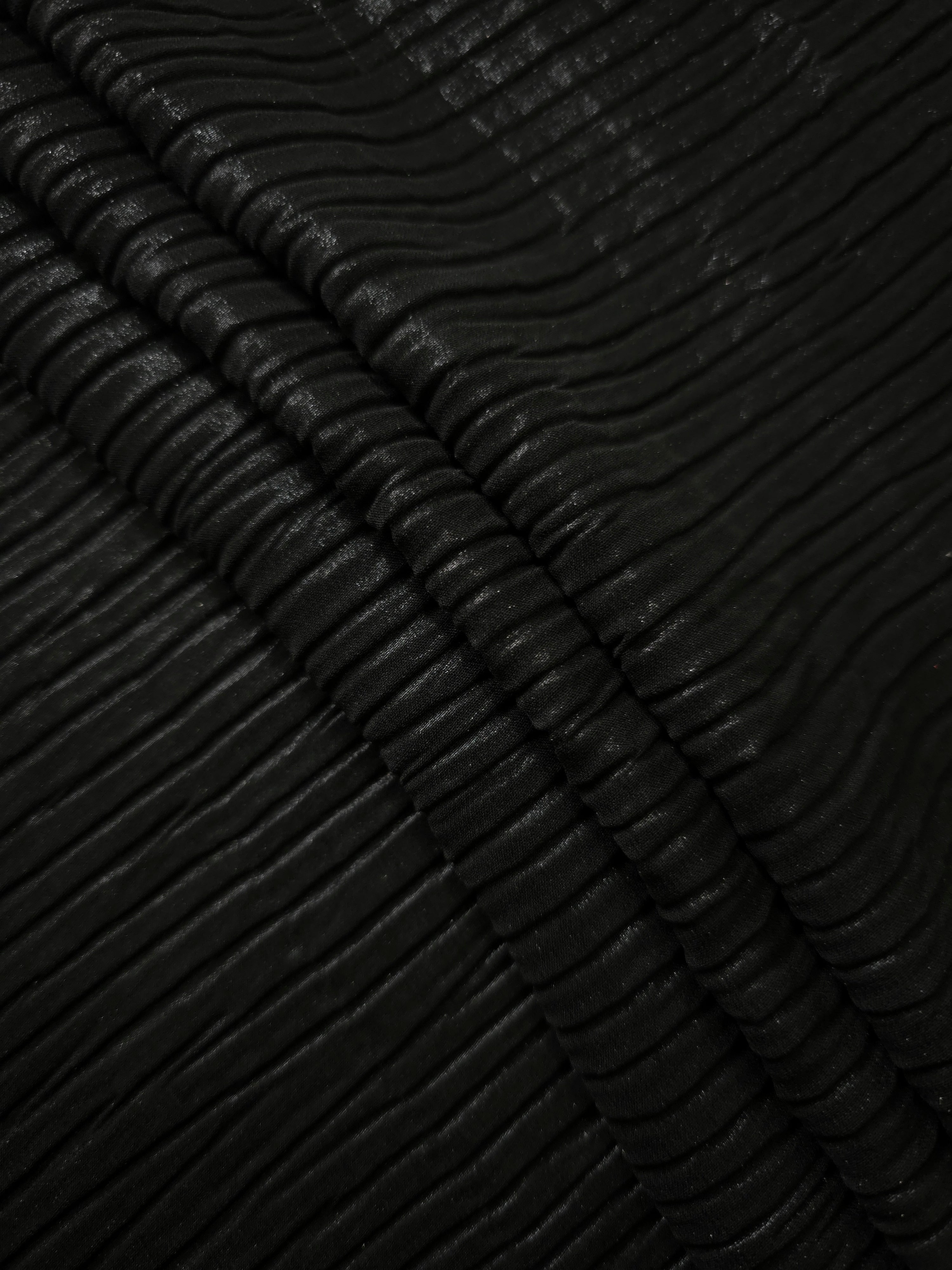 Jet Black classic plissé fabric in close detail, revealing the fine shimmer and dimensional pleat structure suited to bodice accents and fashion-forward blouses.