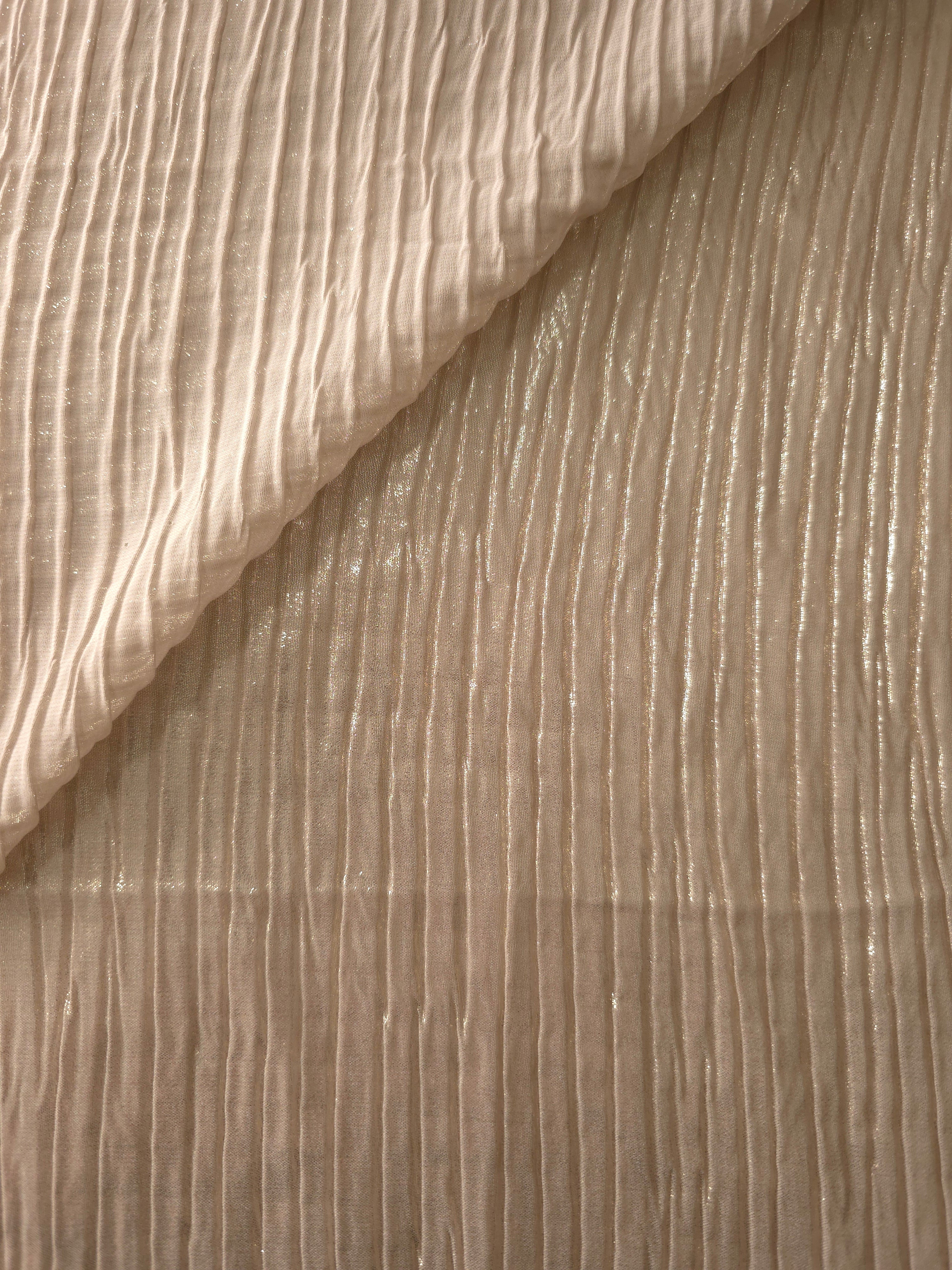 Fold detail of Light Cream classic plissé fabric demonstrates how the textured surface builds depth for stagewear and layered fashion details.