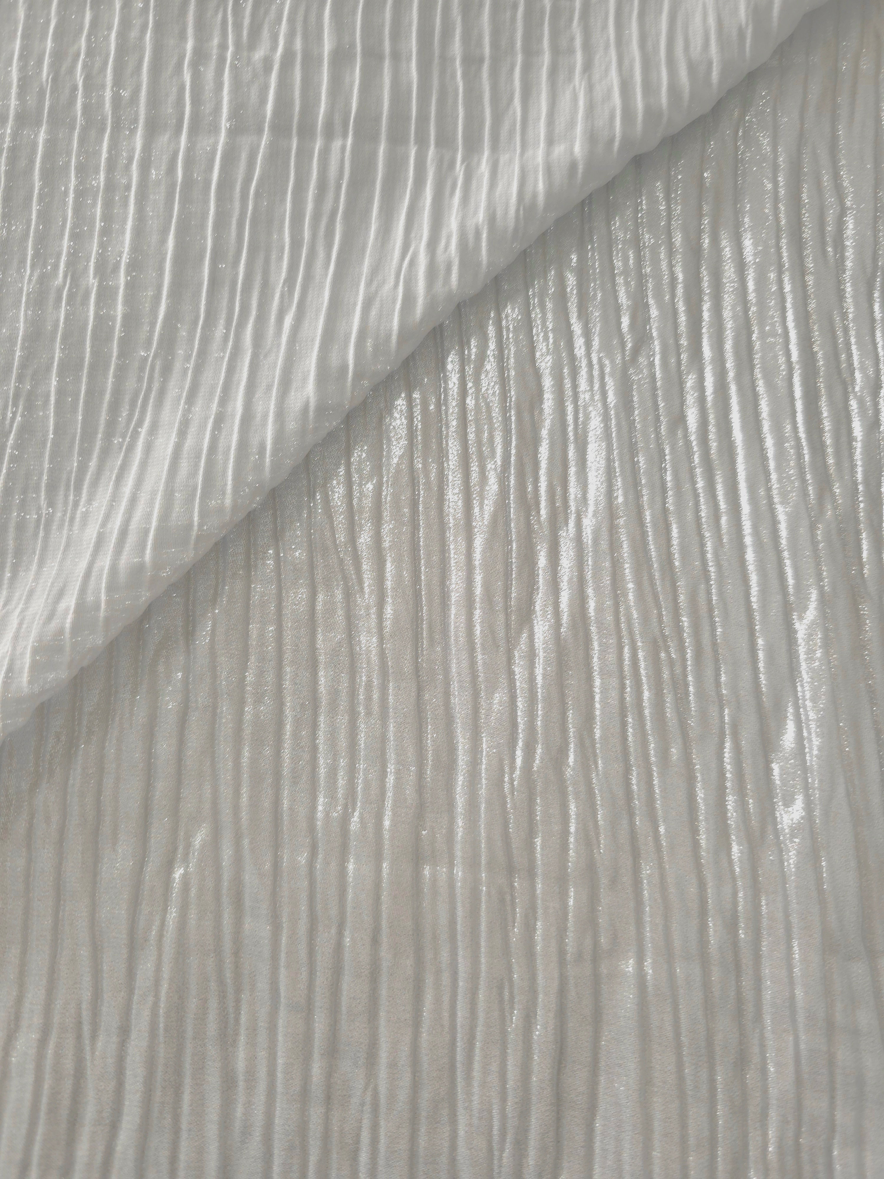 Fold detail of Pearl Gray classic plissé fabric demonstrates how the textured surface builds depth for stagewear and layered fashion details.