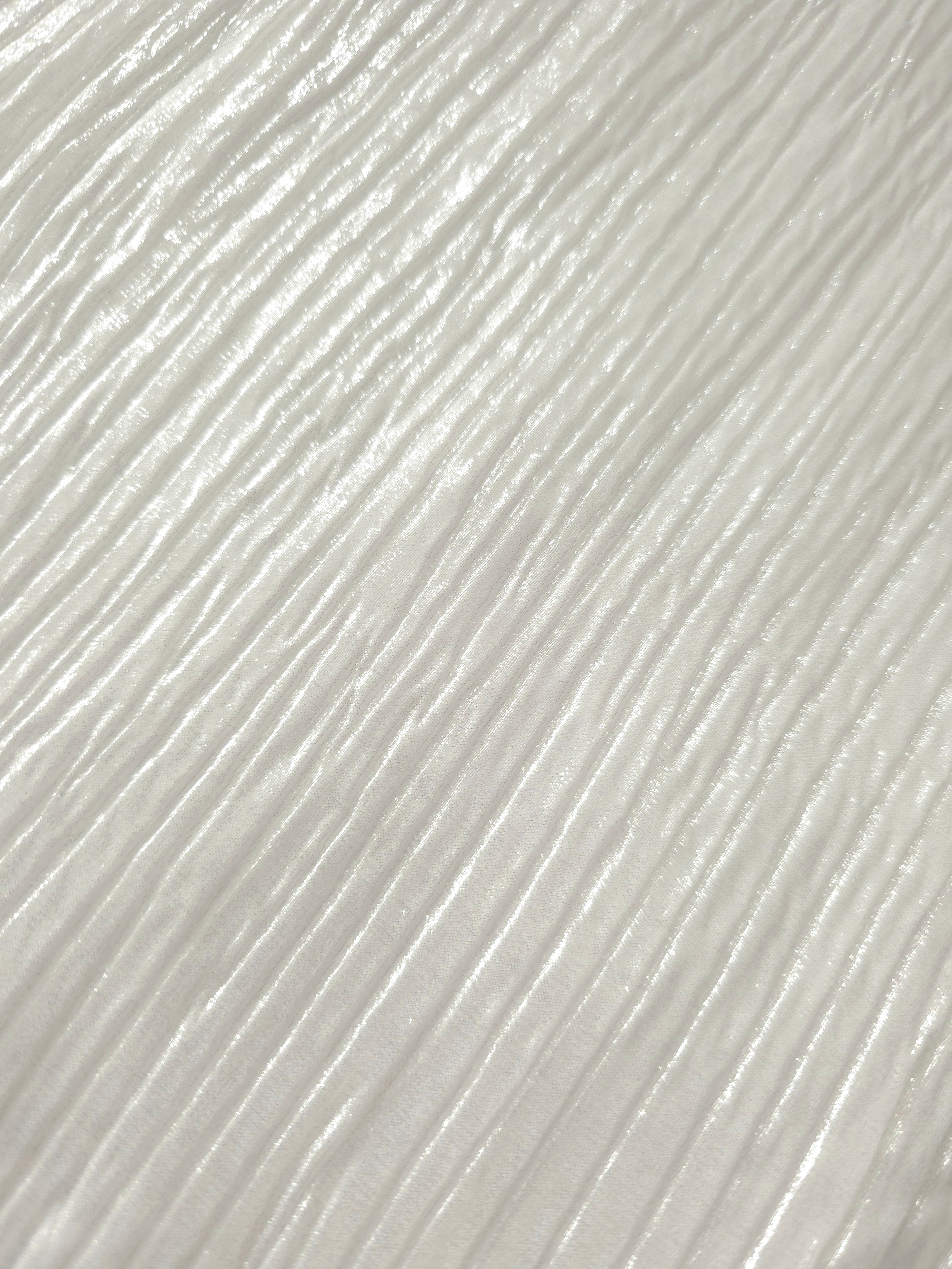 Soft drape of Pearl White textured shimmer plissé reveals dimensional folds and shifting reflection for jumpsuits and fluid occasionwear.