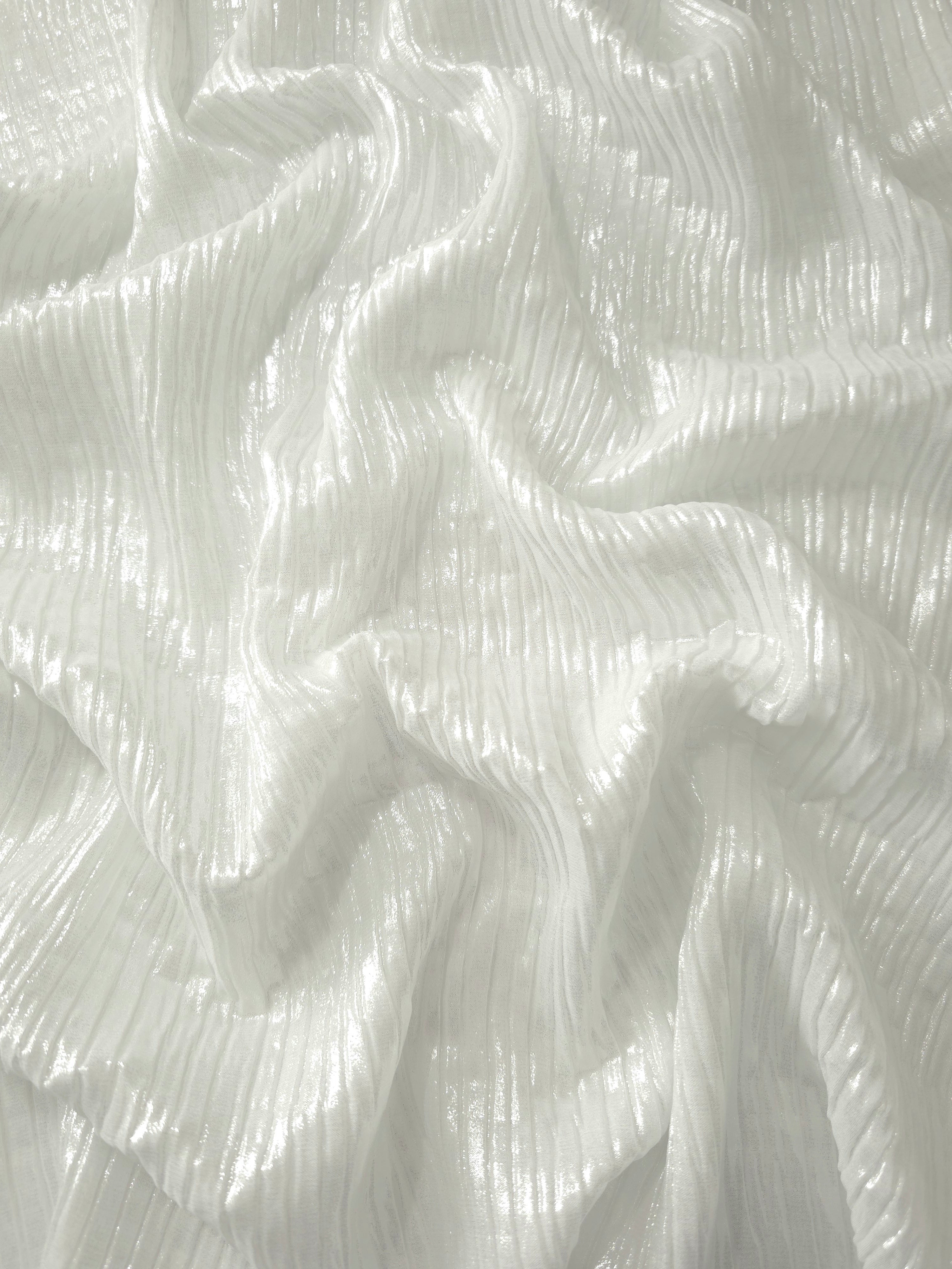 Flowing drape of Pearl White classic plissé shimmer fabric, showing regular pleated texture and light-catching movement for evening gowns and flowing maxi skirts.