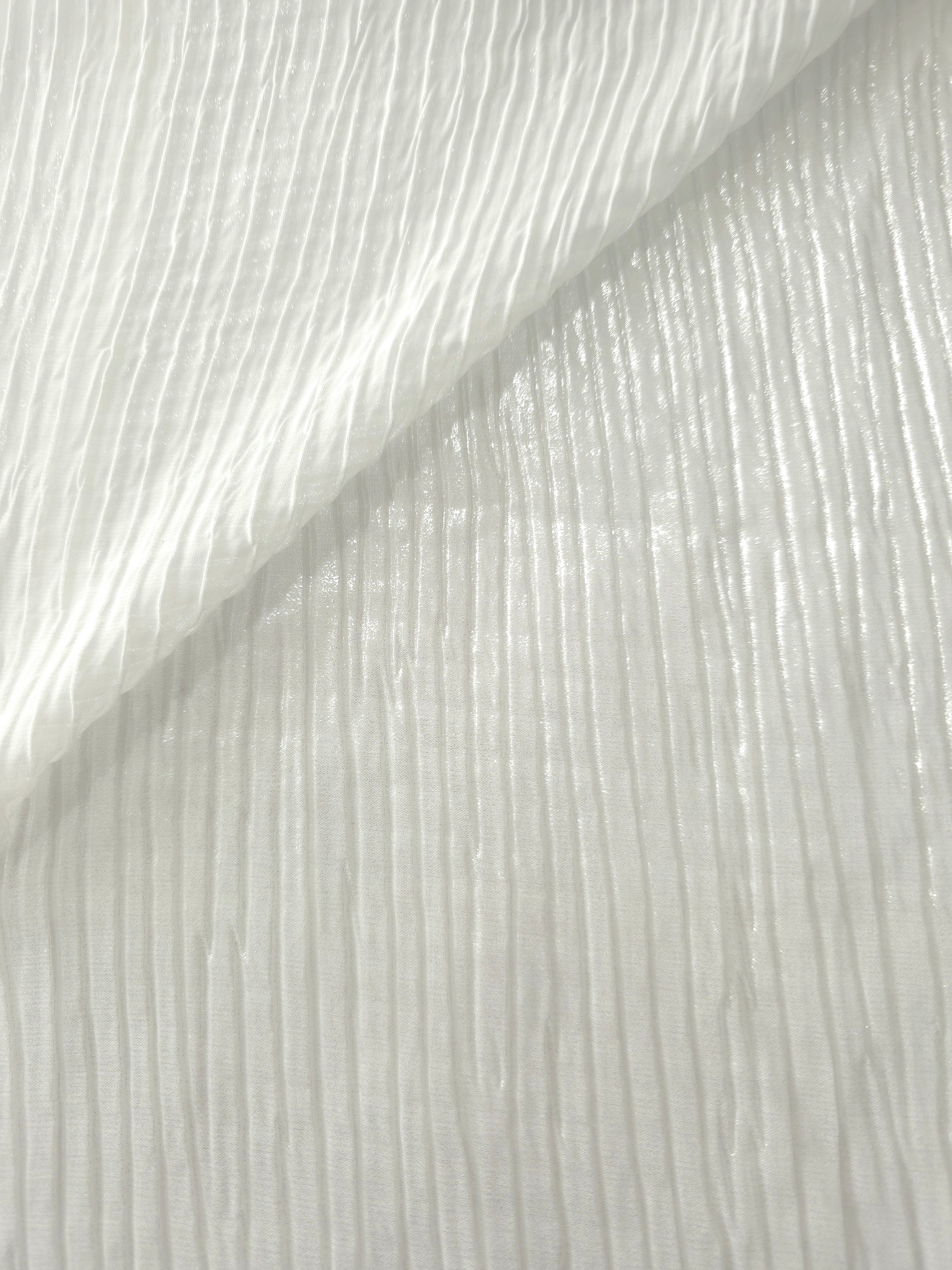 Fold detail of Pearl White classic plissé fabric demonstrates how the textured surface builds depth for stagewear and layered fashion details.