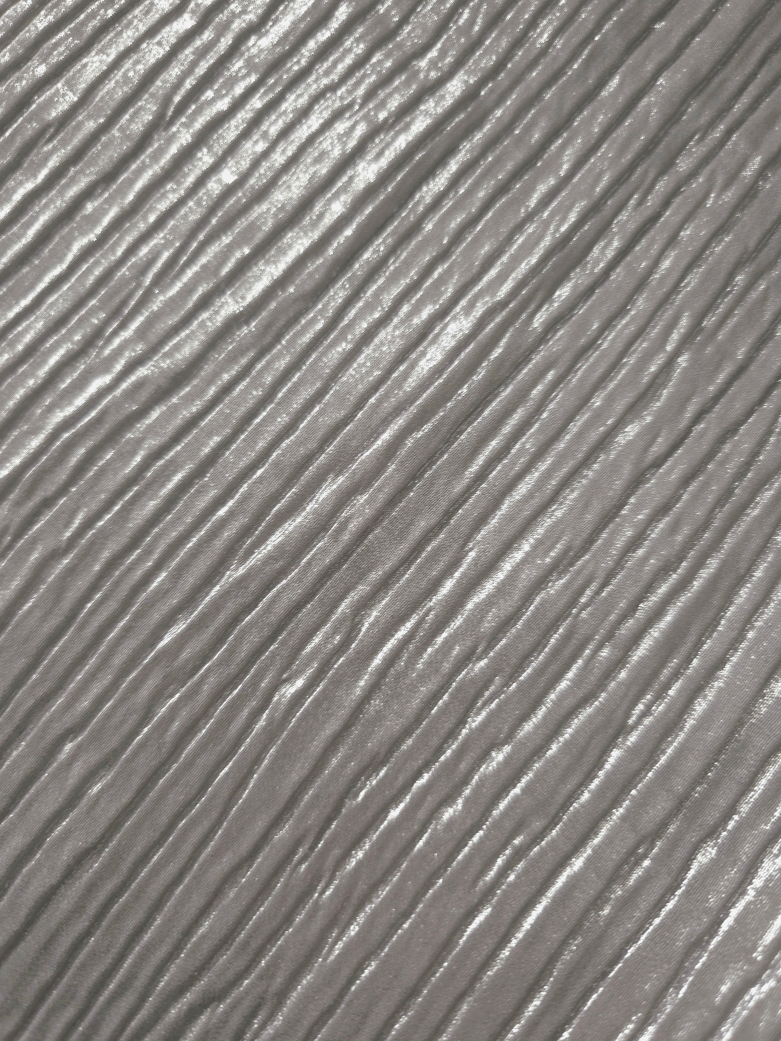 Soft drape of Silver Gray textured shimmer plissé reveals dimensional folds and shifting reflection for jumpsuits and fluid occasionwear.