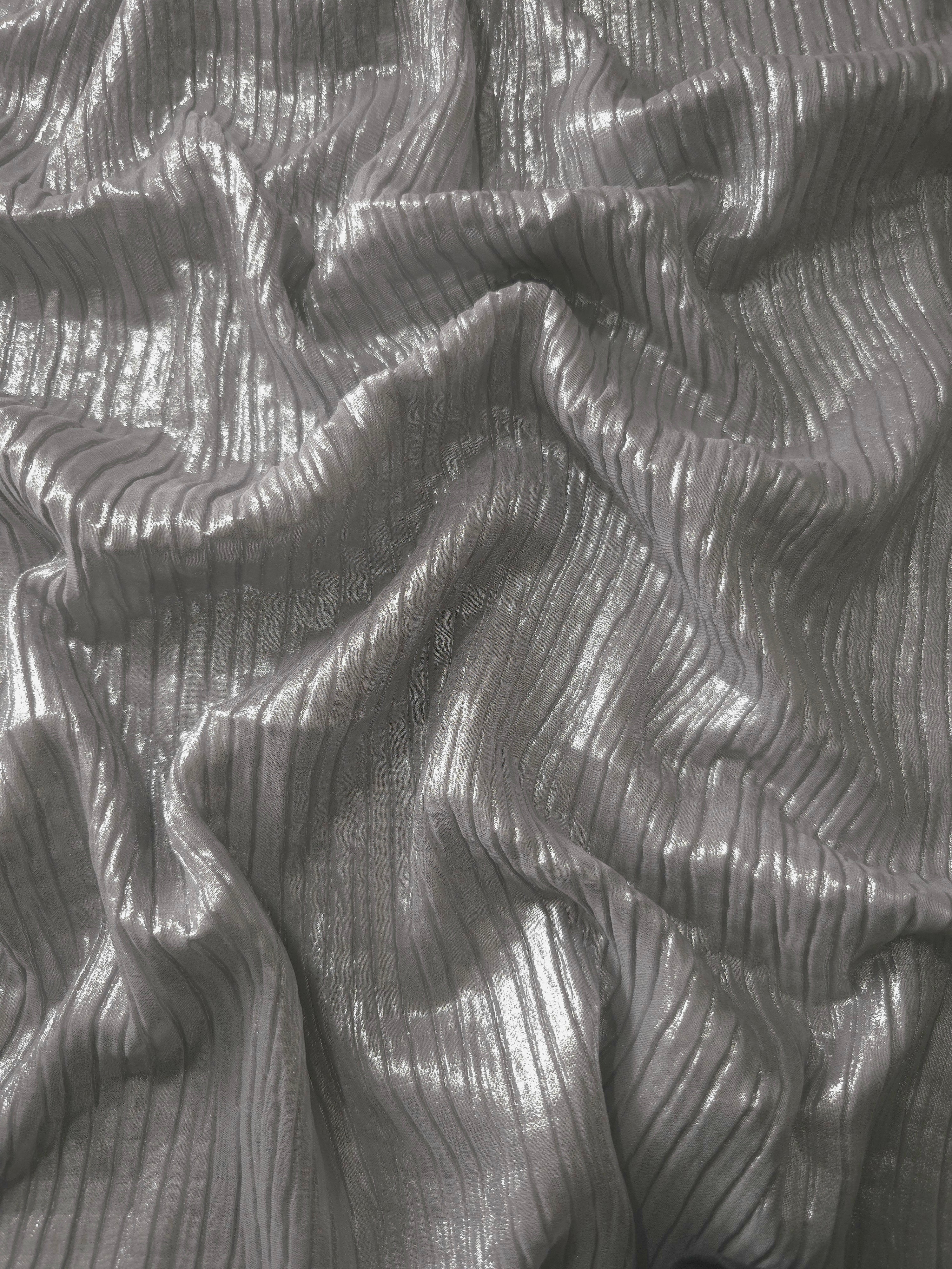 Flowing drape of Silver Gray classic plissé shimmer fabric, showing regular pleated texture and light-catching movement for evening gowns and flowing maxi skirts.
