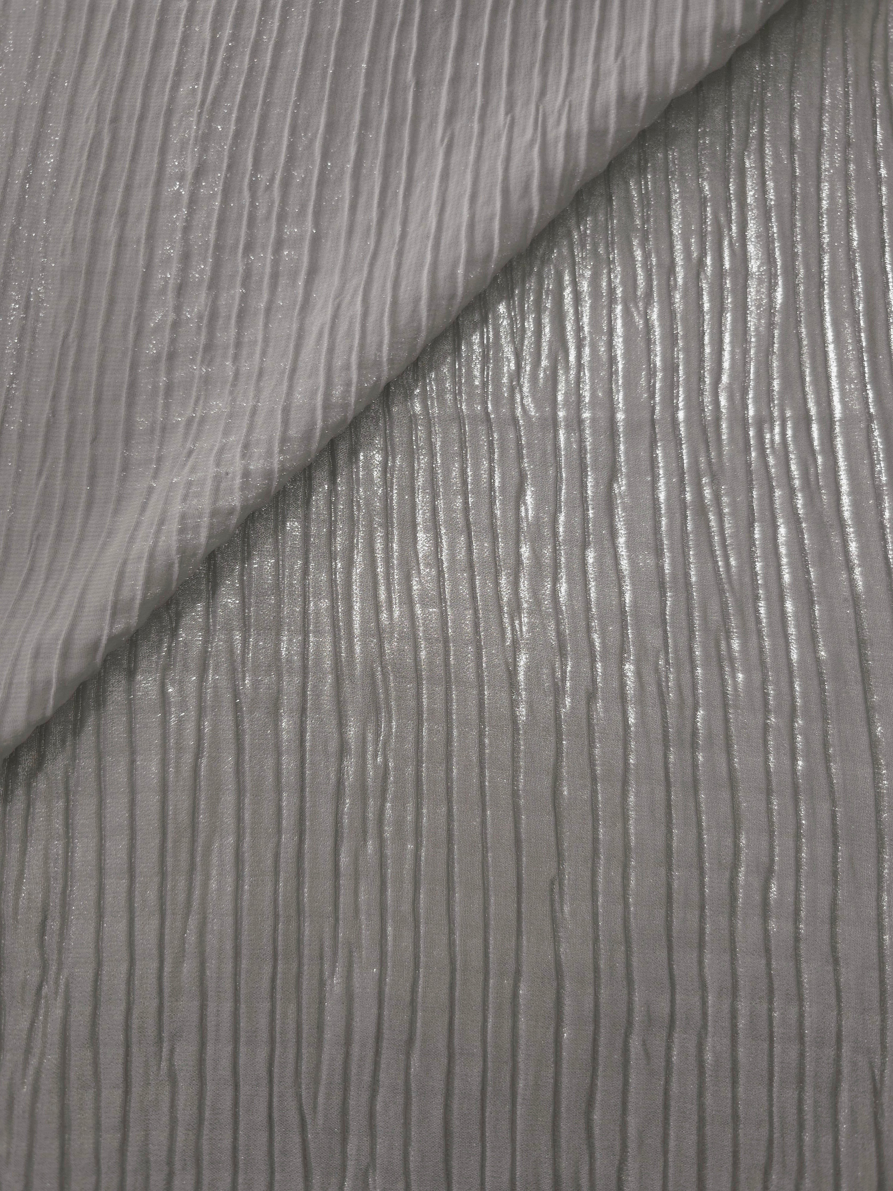 Fold detail of Silver Gray classic plissé fabric demonstrates how the textured surface builds depth for stagewear and layered fashion details.