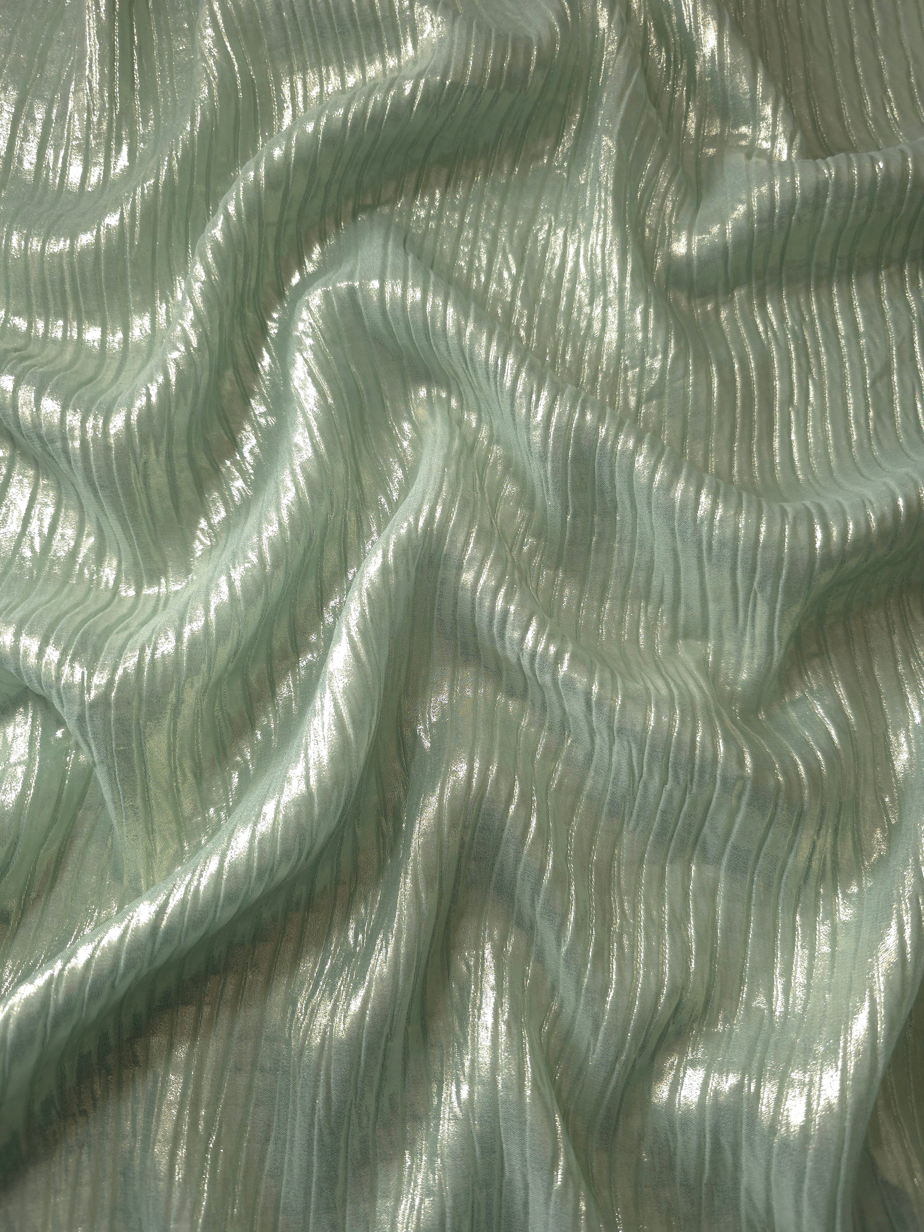 Flowing drape of Soft Sage classic plissé shimmer fabric, showing regular pleated texture and light-catching movement for evening gowns and flowing maxi skirts.