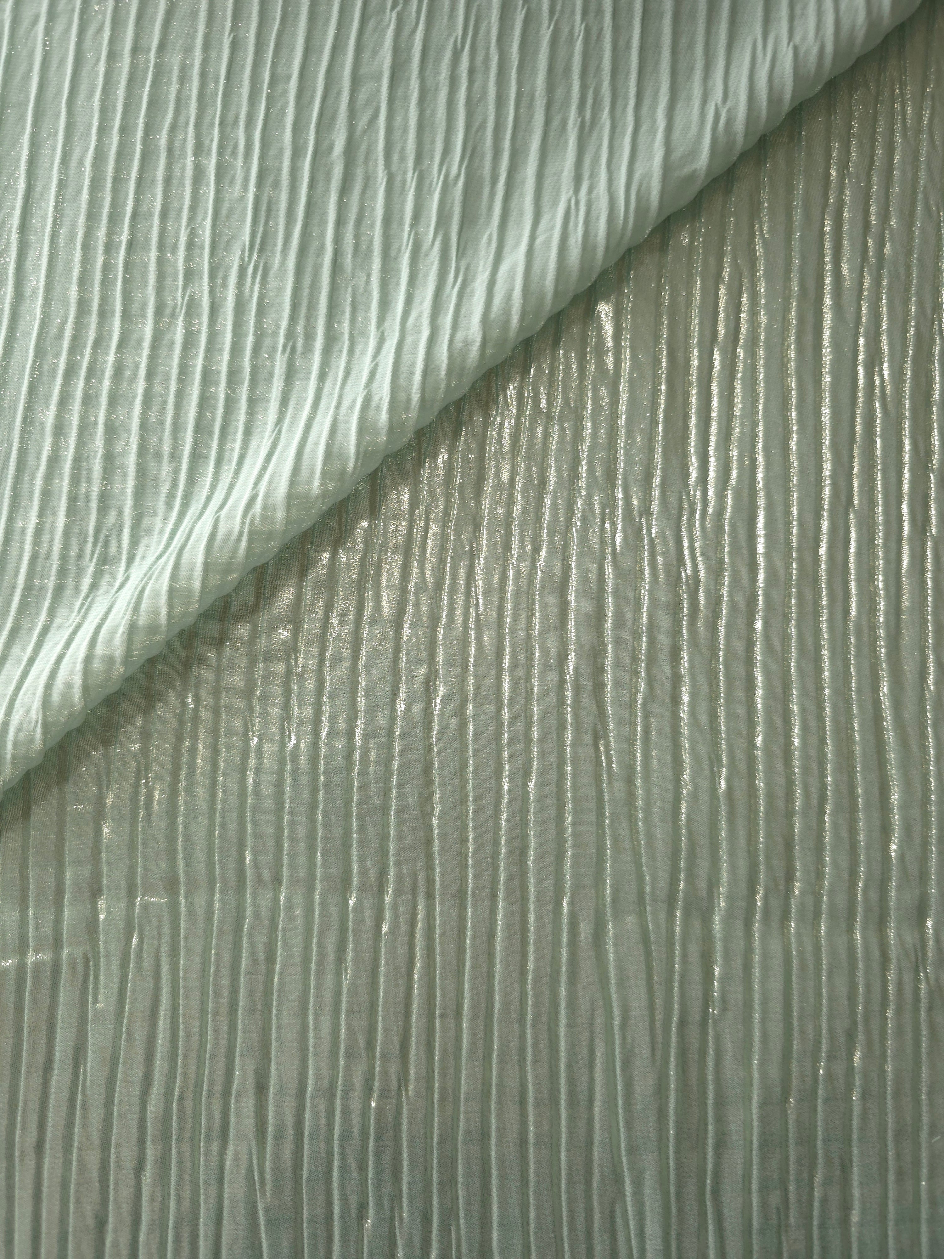 Fold detail of Soft Sage classic plissé fabric demonstrates how the textured surface builds depth for stagewear and layered fashion details.