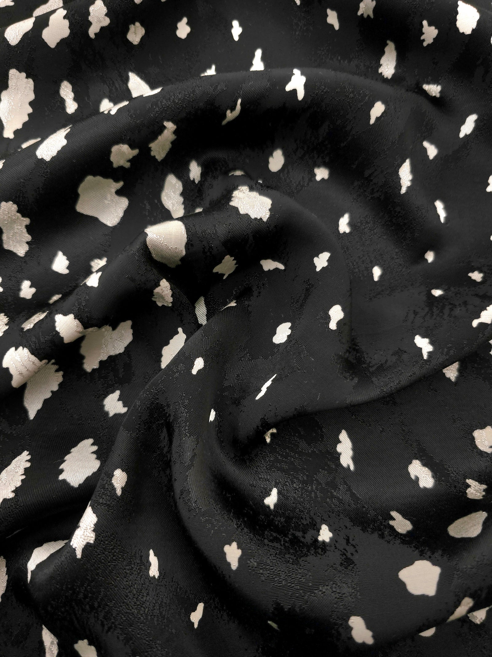 Ivory pebble scatter Turkish rayon viscose jacquard fabric on black base