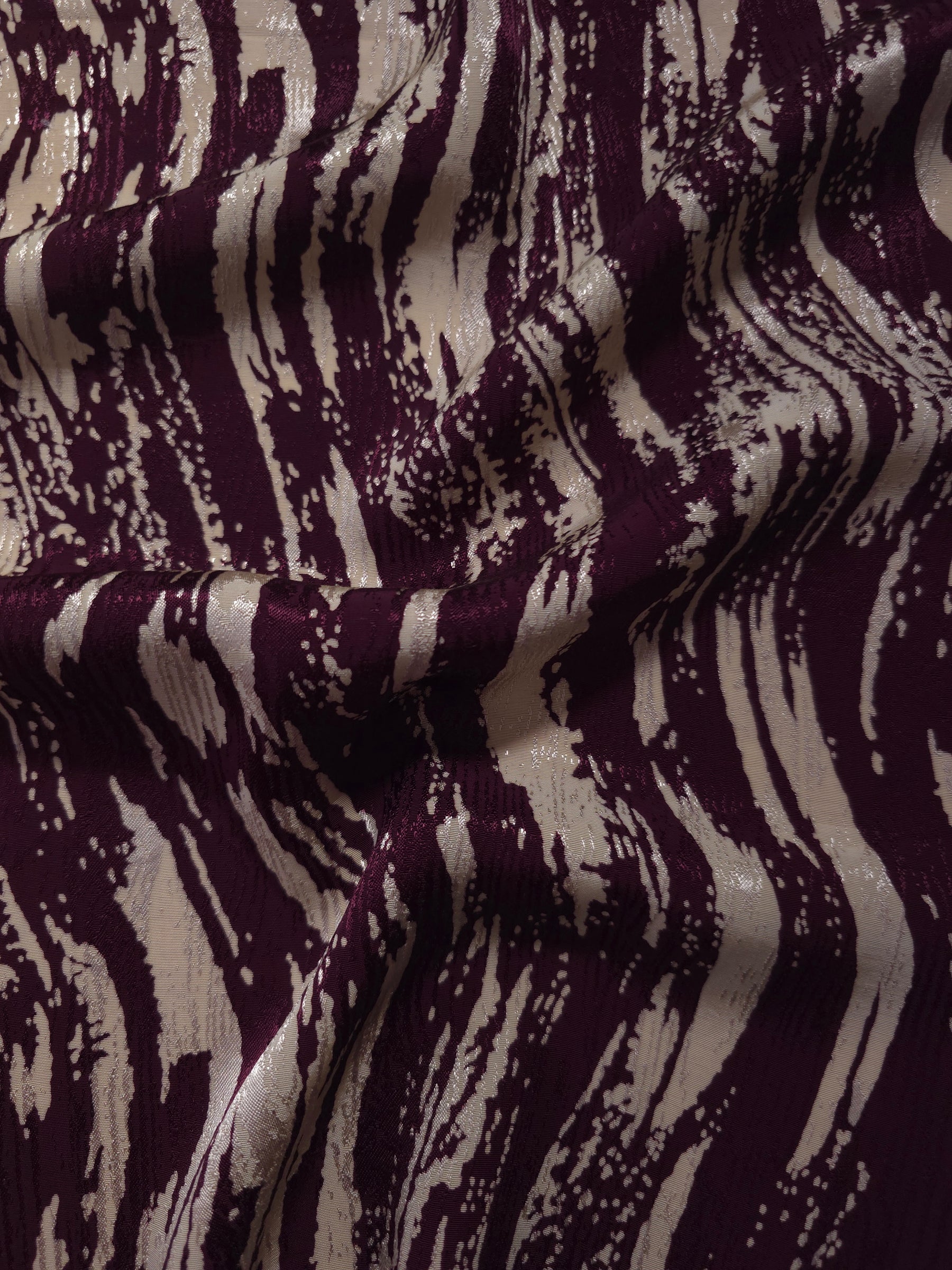 Cream Line printed jacquard fabric in a wave fold, showing print and texture