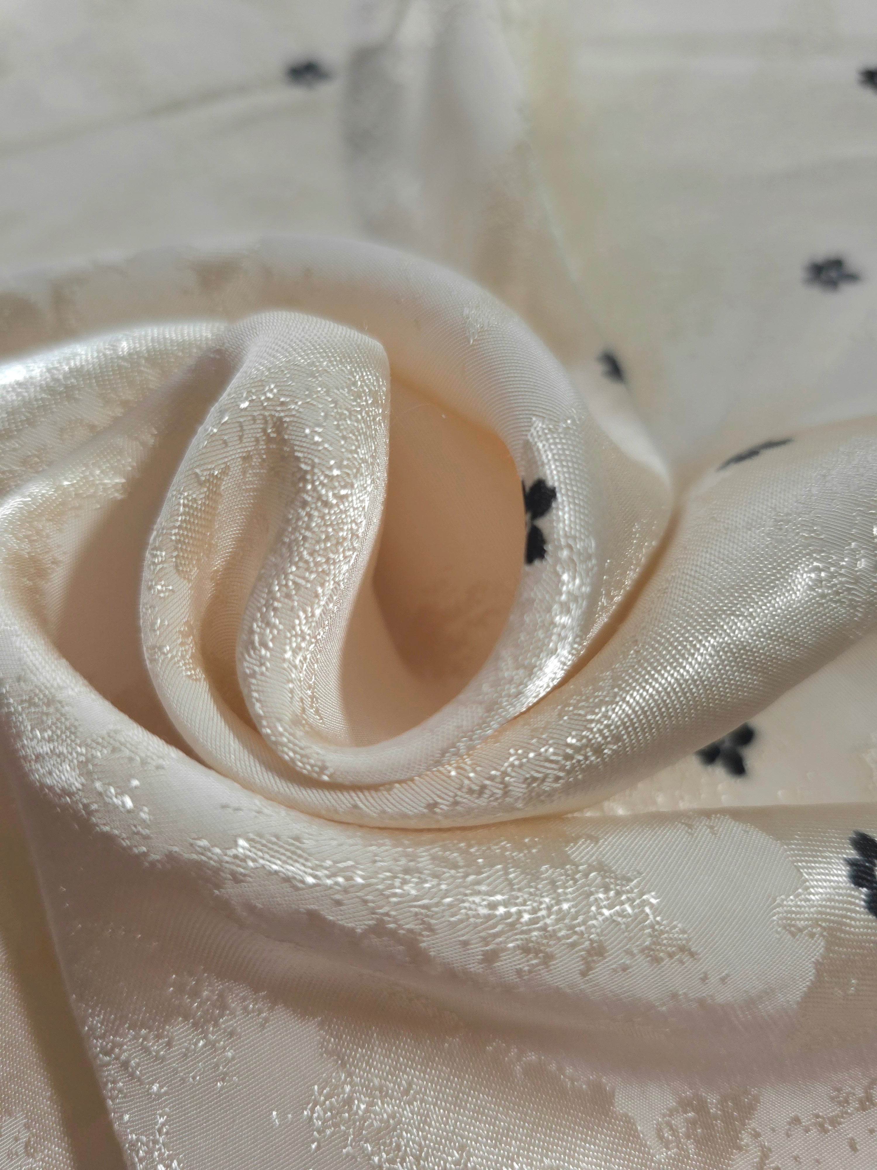 Close-up of draped Flower printed jacquard fabric showing fold detail