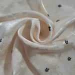 Flower rotary print on Turkish jacquard fabric, draped showing fluid movement
