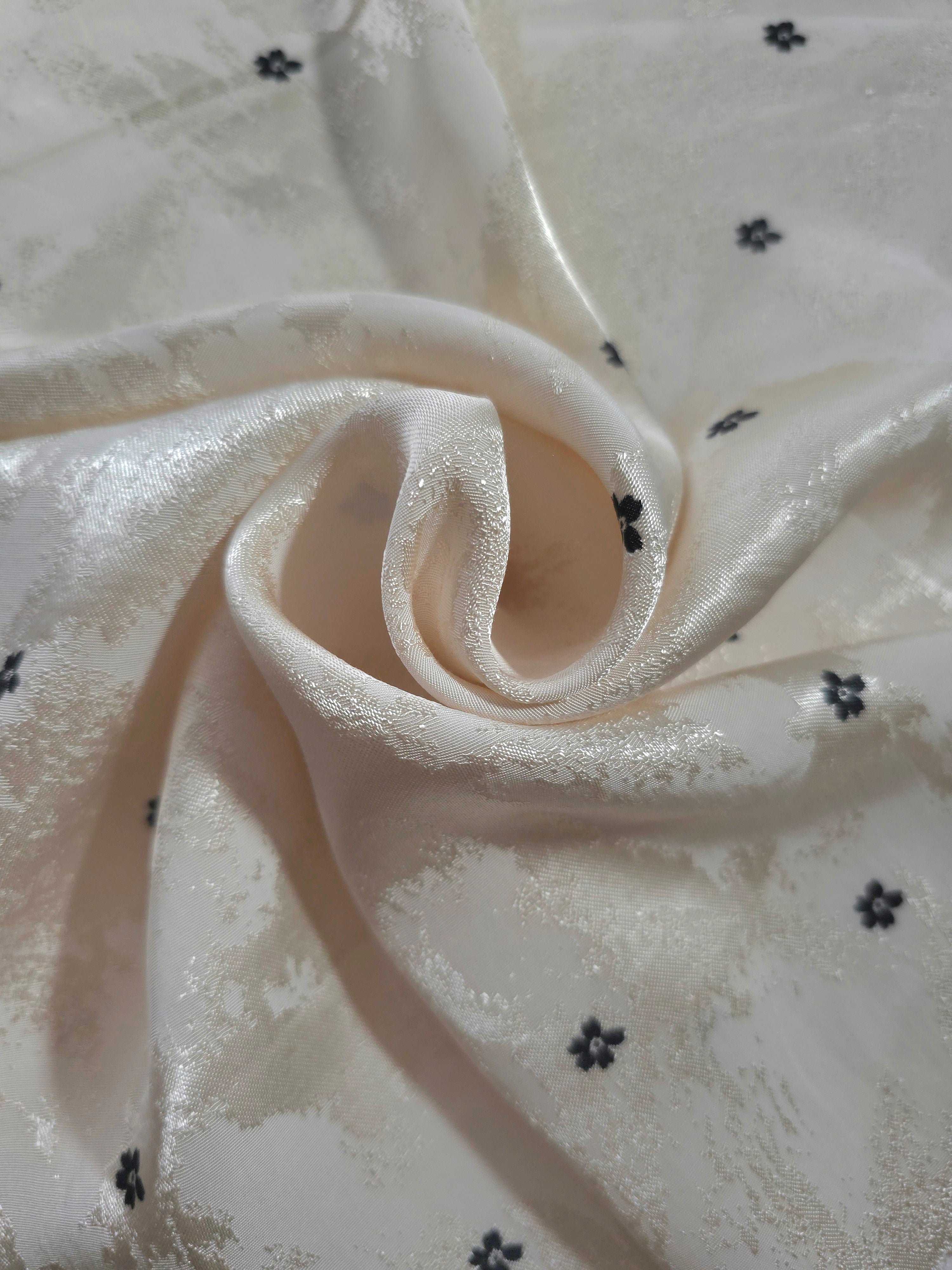 Flower rotary print on Turkish jacquard fabric, draped showing fluid movement