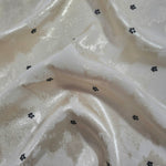 Flower printed jacquard fabric in a wave fold, showing print and texture