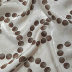 Polka Dot Chain printed jacquard fabric in a wave fold, showing print and texture
