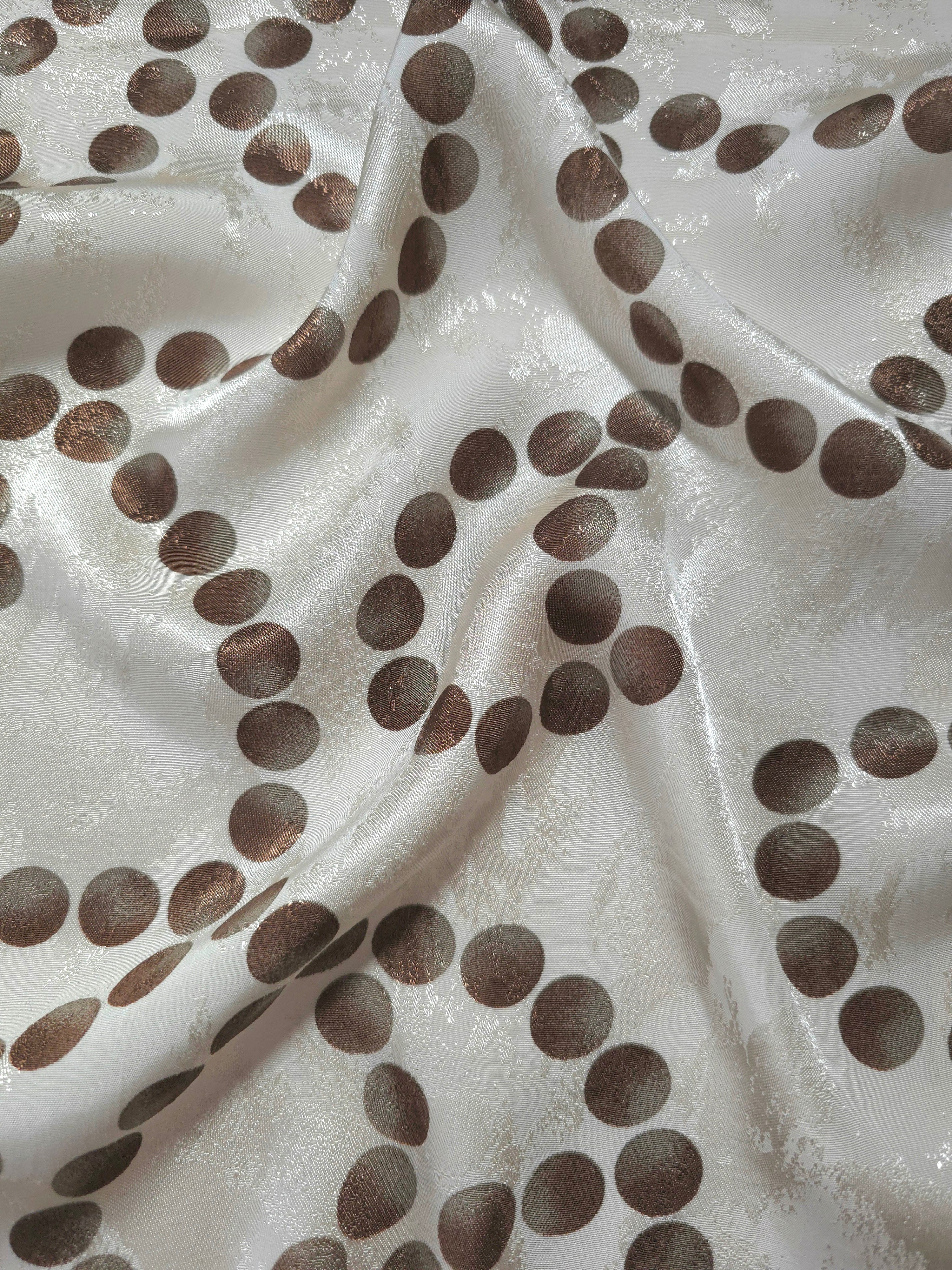 Polka Dot Chain printed jacquard fabric in a wave fold, showing print and texture