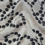 Polka Dot Chain printed jacquard fabric in a wave fold, showing print and texture