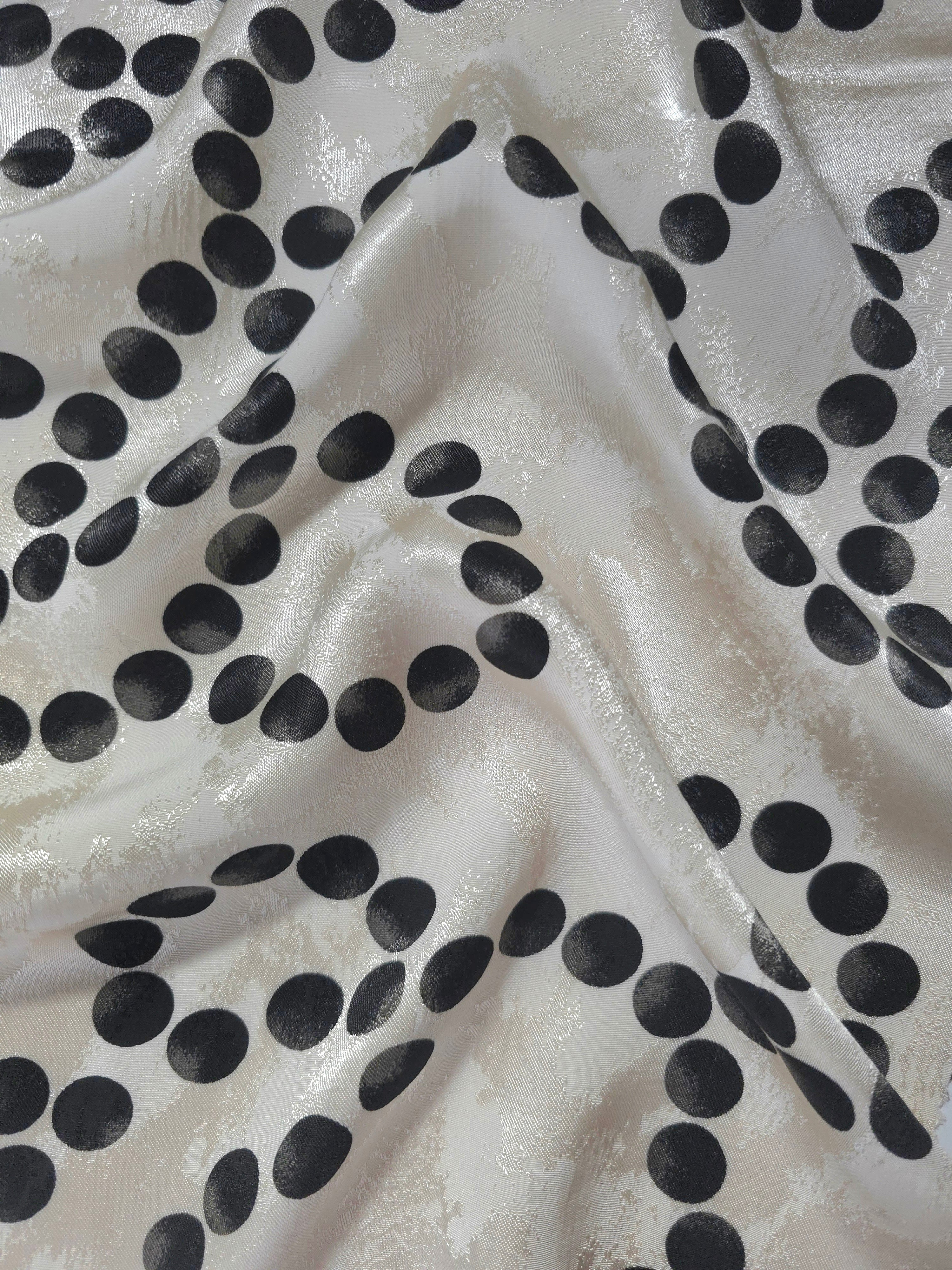 Polka Dot Chain printed jacquard fabric in a wave fold, showing print and texture