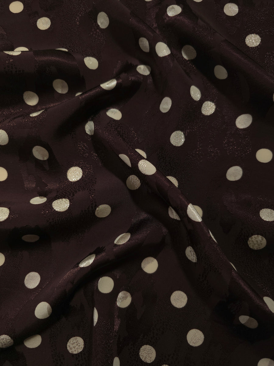 Polka Dot printed jacquard fabric in a wave fold, showing print and texture