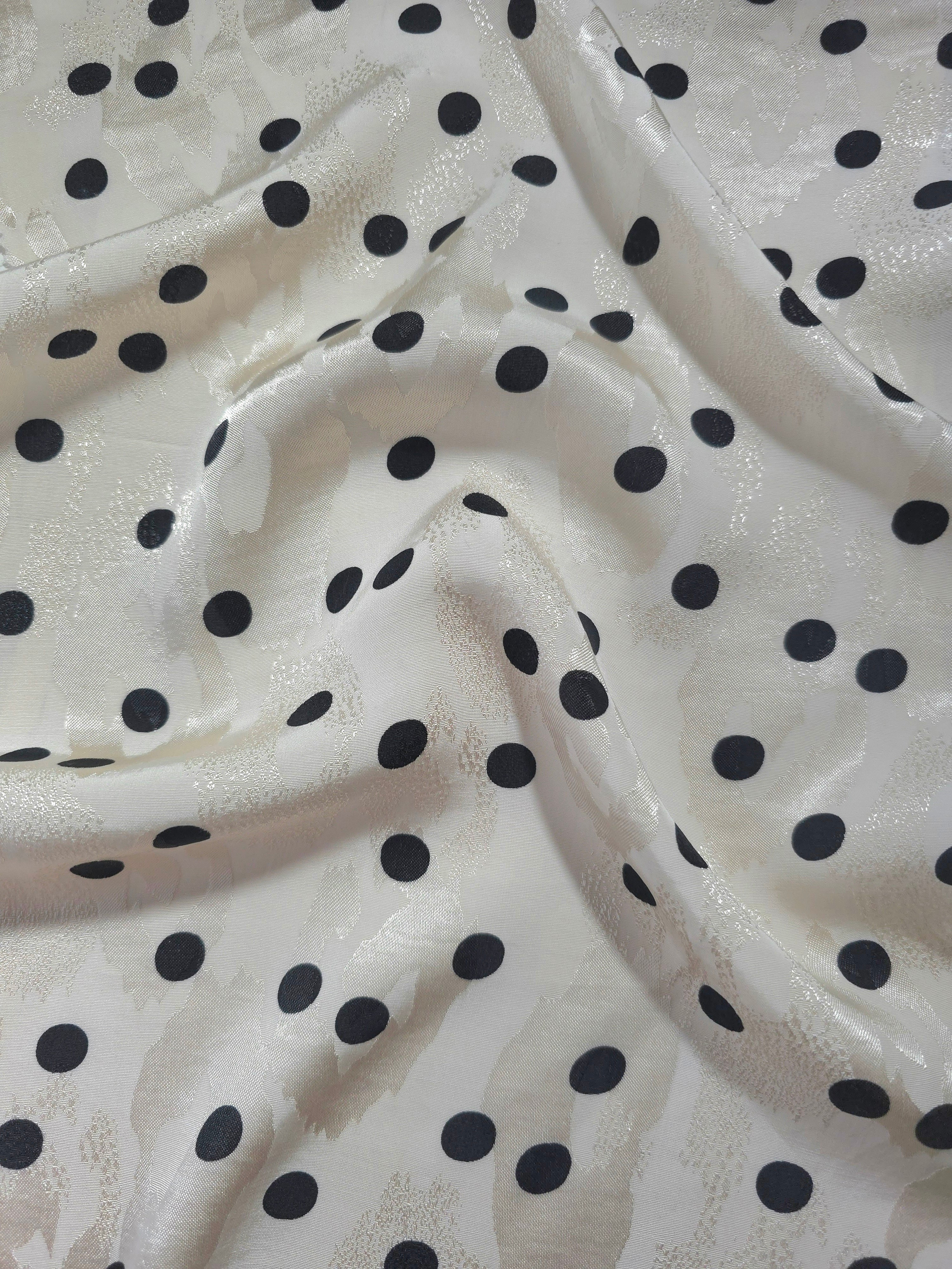 Polka Dot printed jacquard fabric in a wave fold, showing print and texture