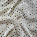 Small Flower printed jacquard fabric in a wave fold, showing print and texture