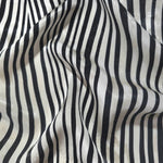 Zebra printed jacquard fabric in a wave fold, showing print and texture