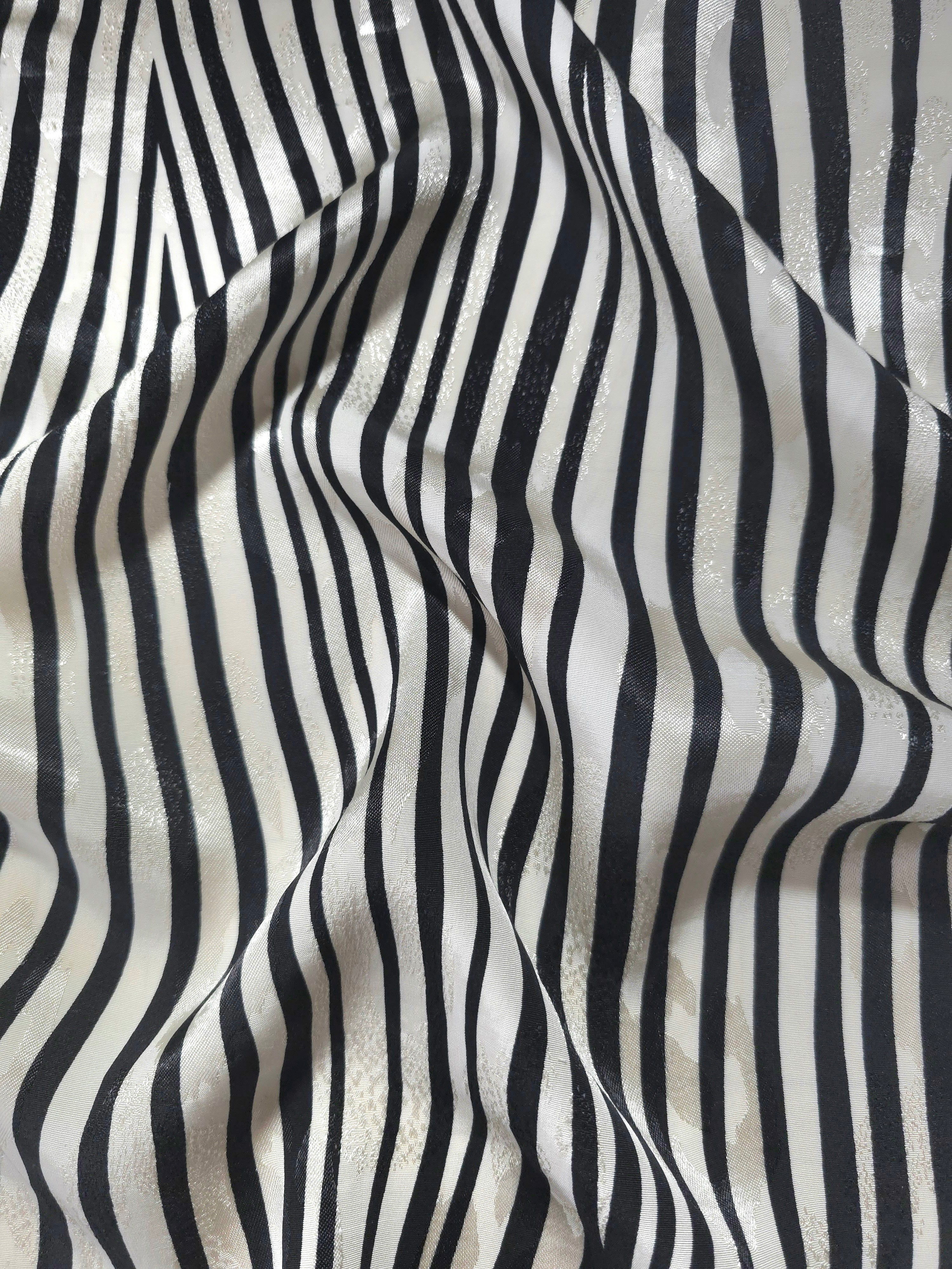 Zebra printed jacquard fabric in a wave fold, showing print and texture