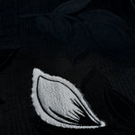 Close-up of viscose embossed two-tone jacquard design with raised texture.
