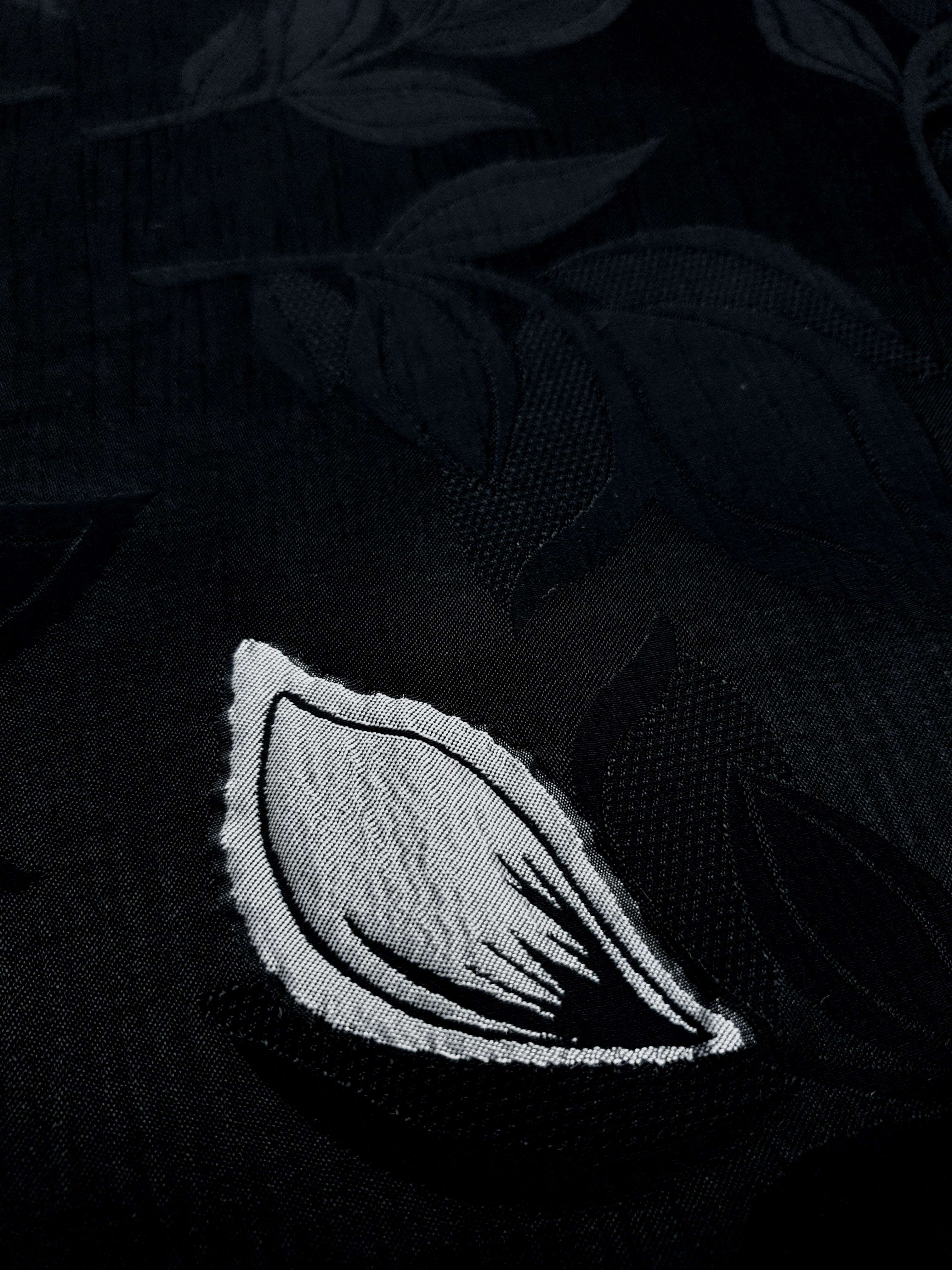 Close-up of viscose embossed two-tone jacquard design with raised texture.