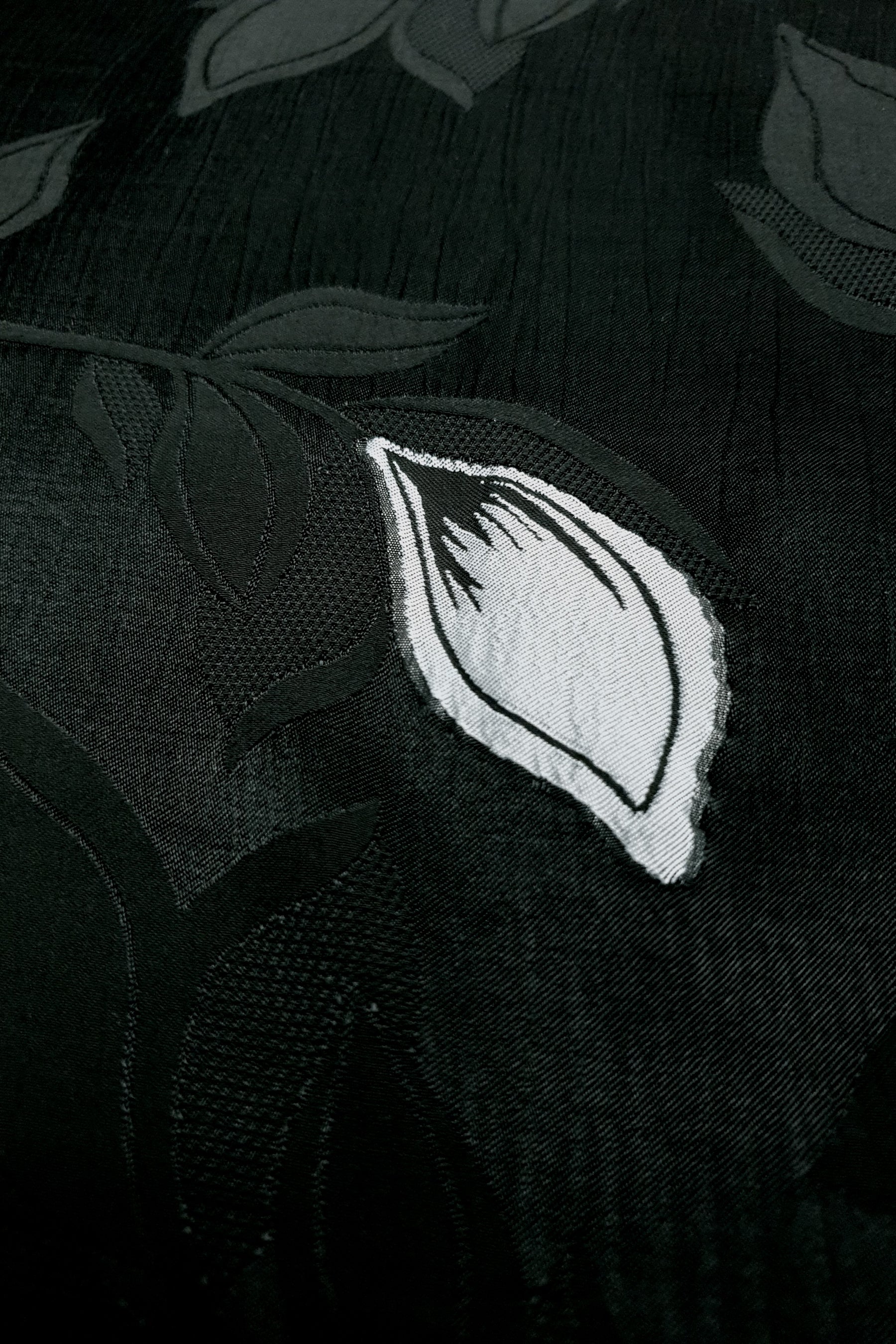 Close texture of viscose embossed two-tone jacquard with raised detail.