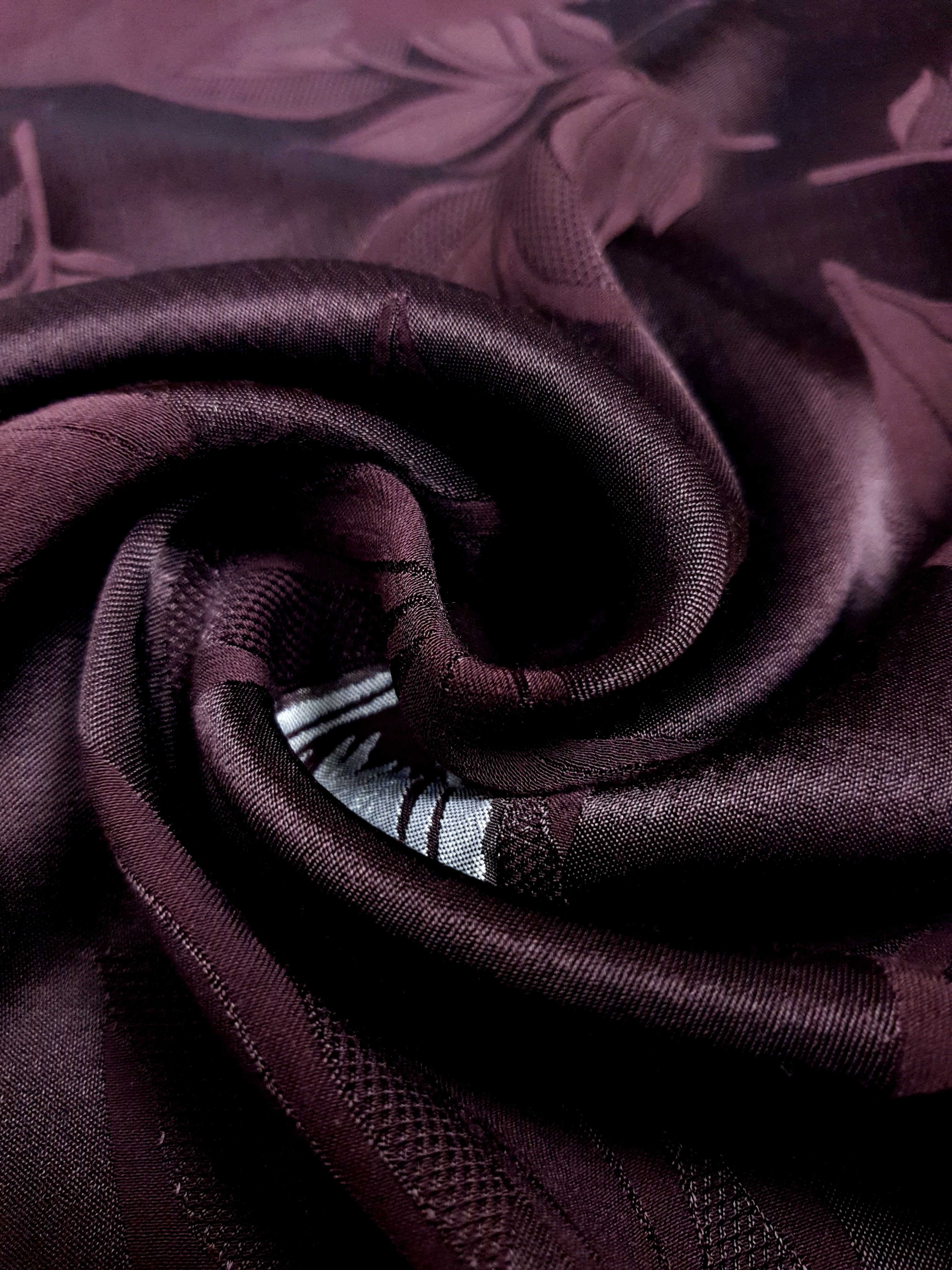 Close drape detail of viscose embossed jacquard with soft texture.