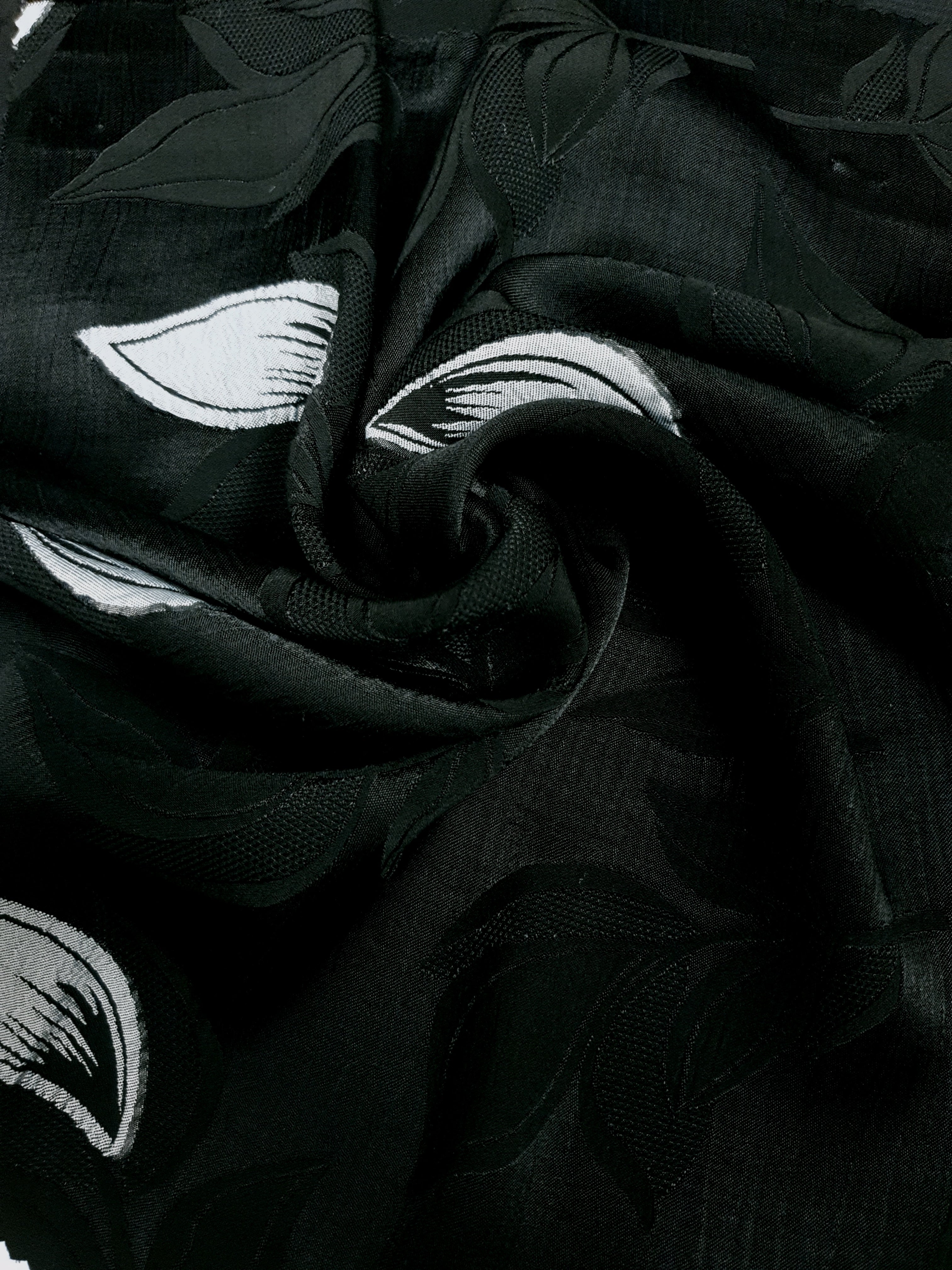 Drape shot of viscose embossed two-tone jacquard fabric for skirts.