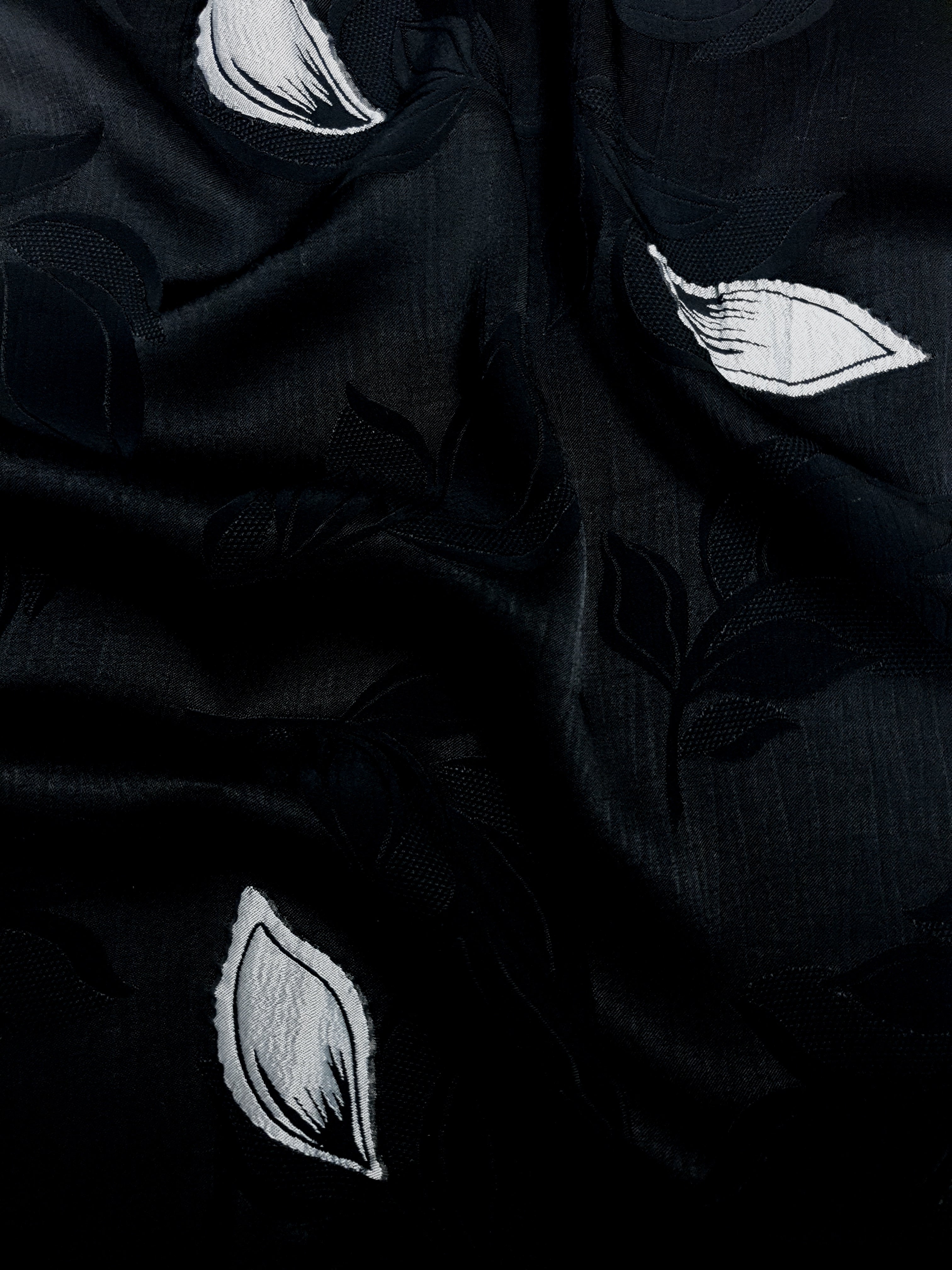 Wave shot of two-tone embossed jacquard fabric with soft drape.