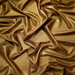 Draped Antique Bronze shimmer spandex fabric with luminous foil reflection, suited to gowns, skirts and theatrical apparel