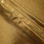 Antique Bronze shimmer spandex fabric stacked in soft layers, revealing metallic reflection for costumes, dresses and creative apparel