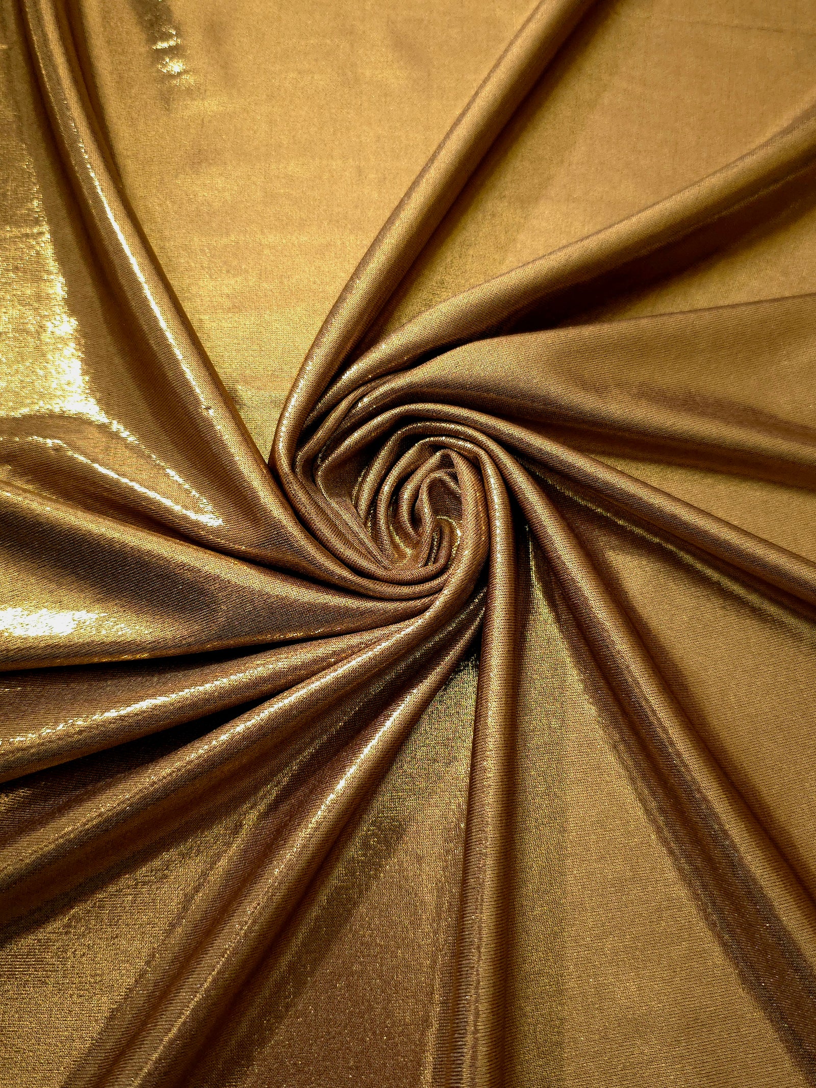 Spiraled Antique Bronze shimmer spandex fabric showing reflective movement for evening dresses, costumes and performance apparel