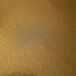 Gently folded Antique Bronze shimmer spandex fabric showing luminous foil finish for tops, skirts and occasion garments