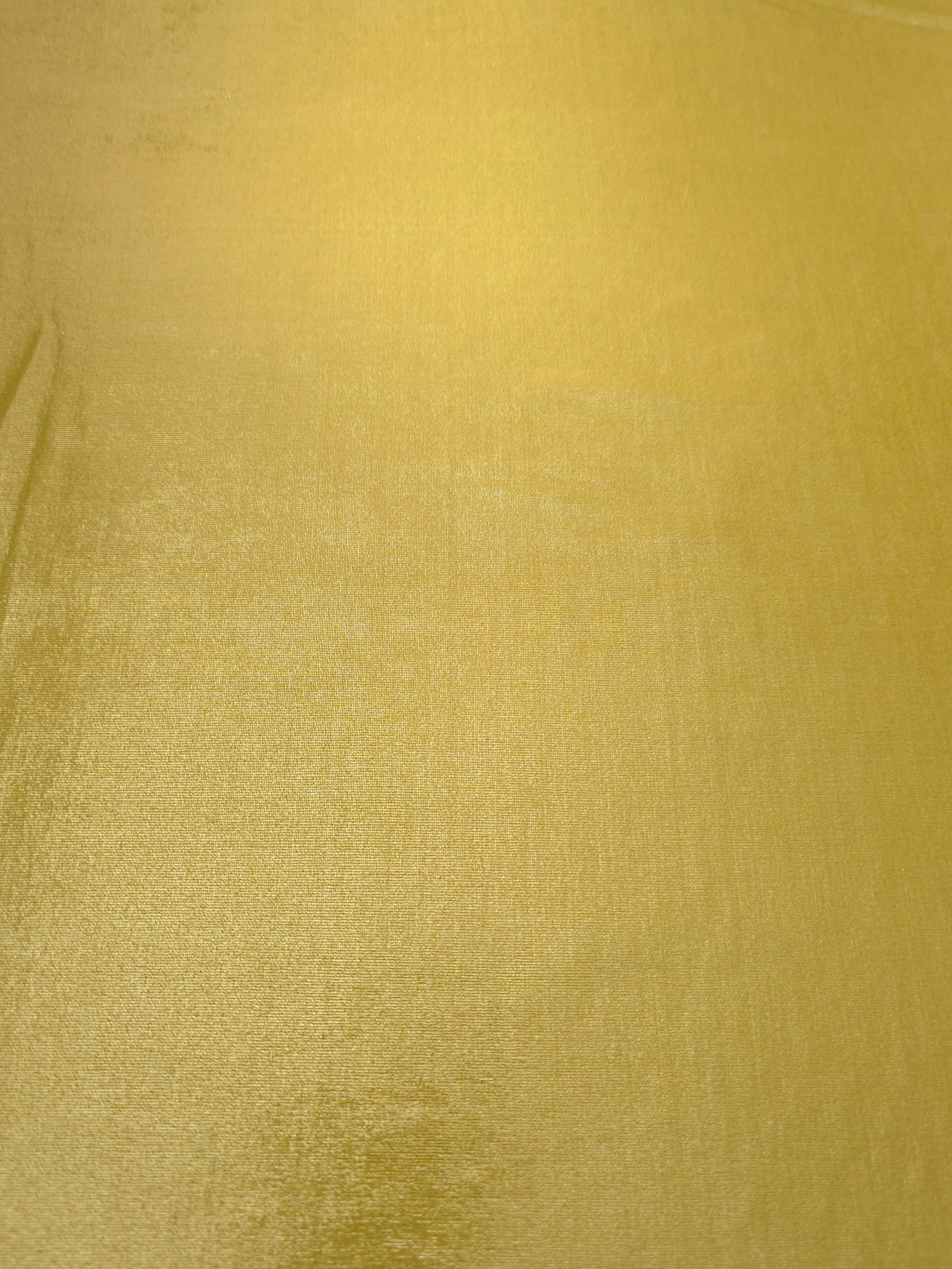 Flat view of Antique Gold shimmer stretch fabric showing its metallic foil surface for costumes, partywear and fashion apparel